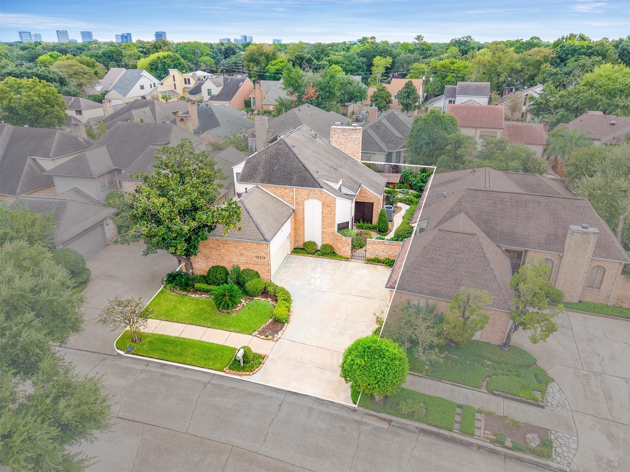 Attractive home with a modern facade, nestled in a lush neighborhood, featuring a spacious driveway and well-maintained landscaping.