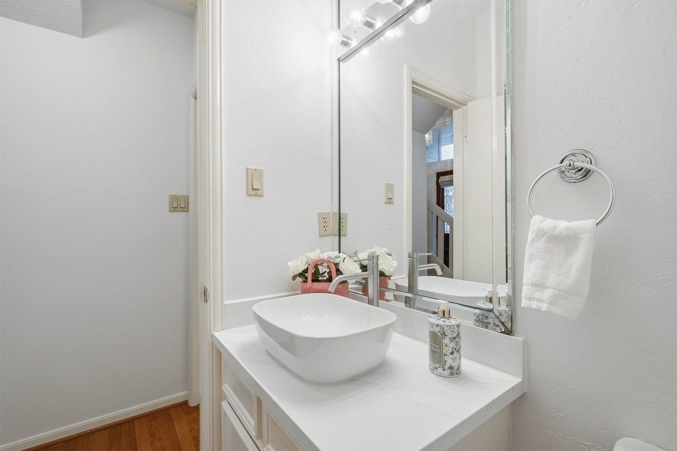 Chic half bath with a sleek vessel sink and modern fixtures, perfect for guests.