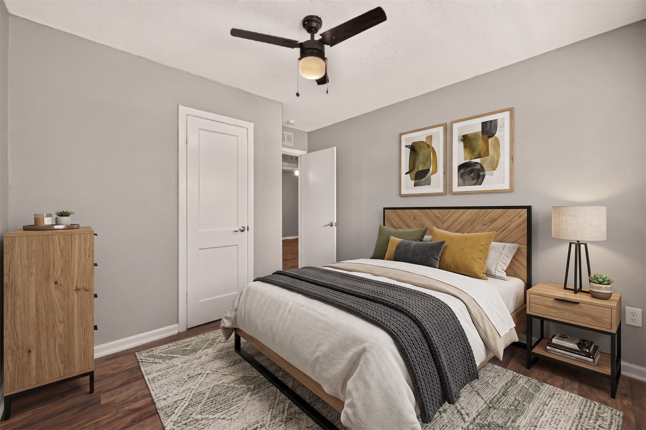 Bedroom 3 with ceiling fan and door to the hall. (Virtually staged)