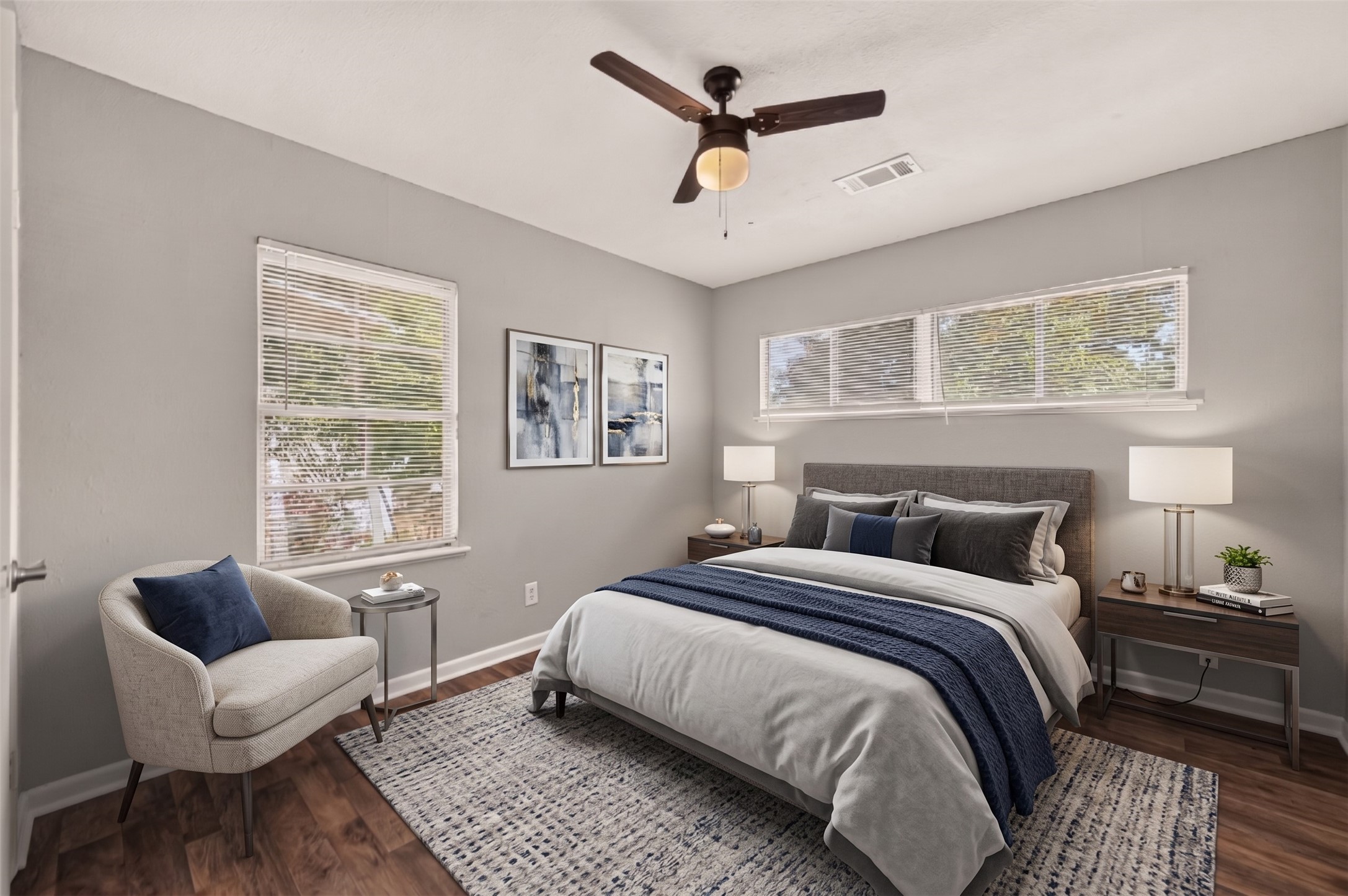 Bedroom 4 with two windows and ceiling fan. (Virtually staged)