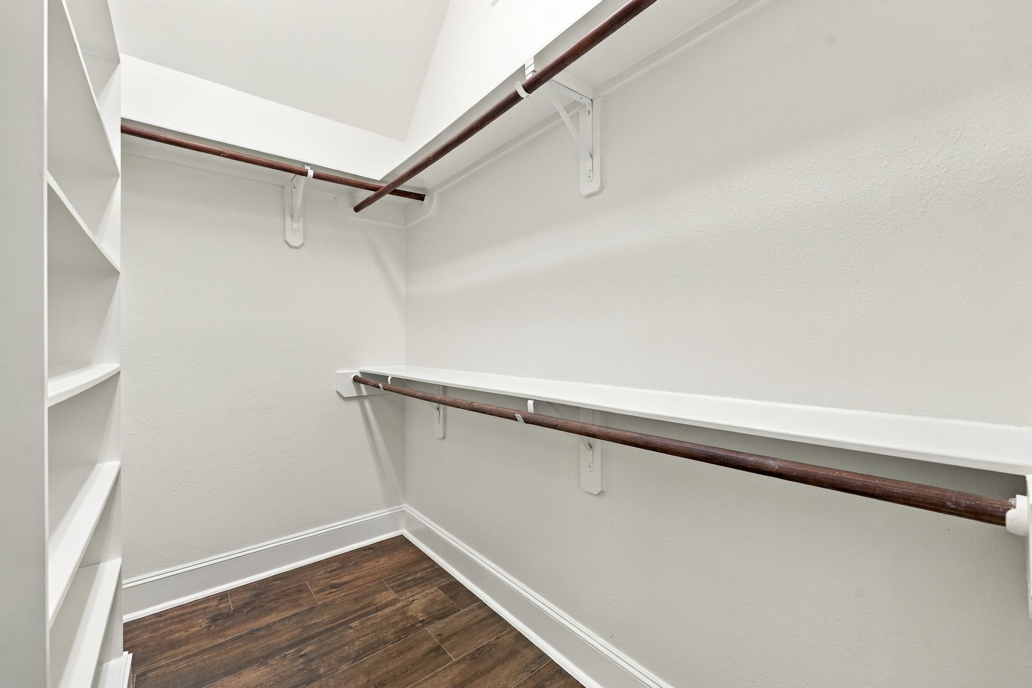 The Primary Suite features two spacious walk-in closets, each thoughtfully designed with built-in storage to keep your wardrobe, shoes, and accessories organized and easily accessible.