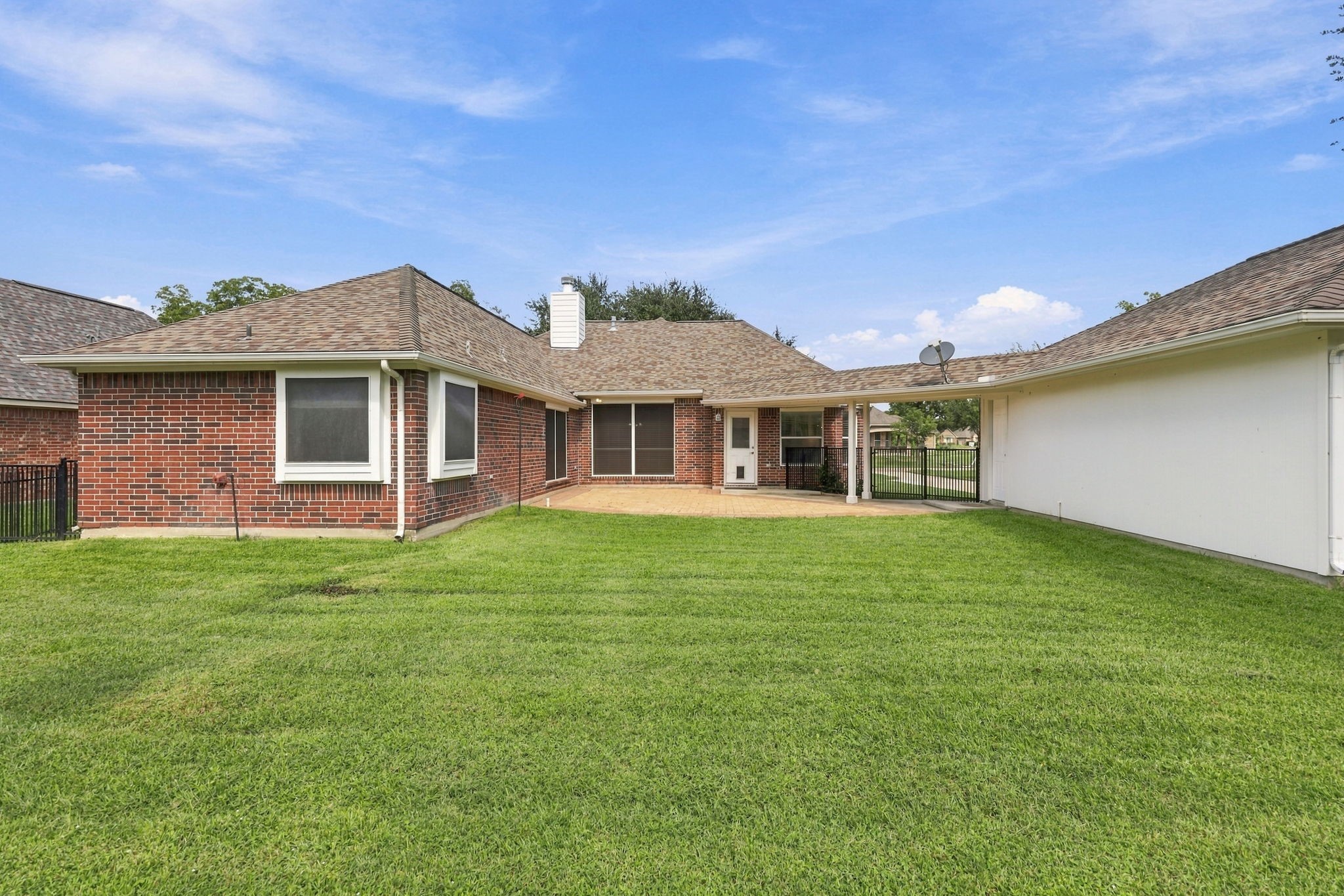 This view looks from the rear of the property toward the back of the house and showcases the impressive length of the oversized detached Garage, offering abundant space for vehicles, storage, hobbies, or a workshop.