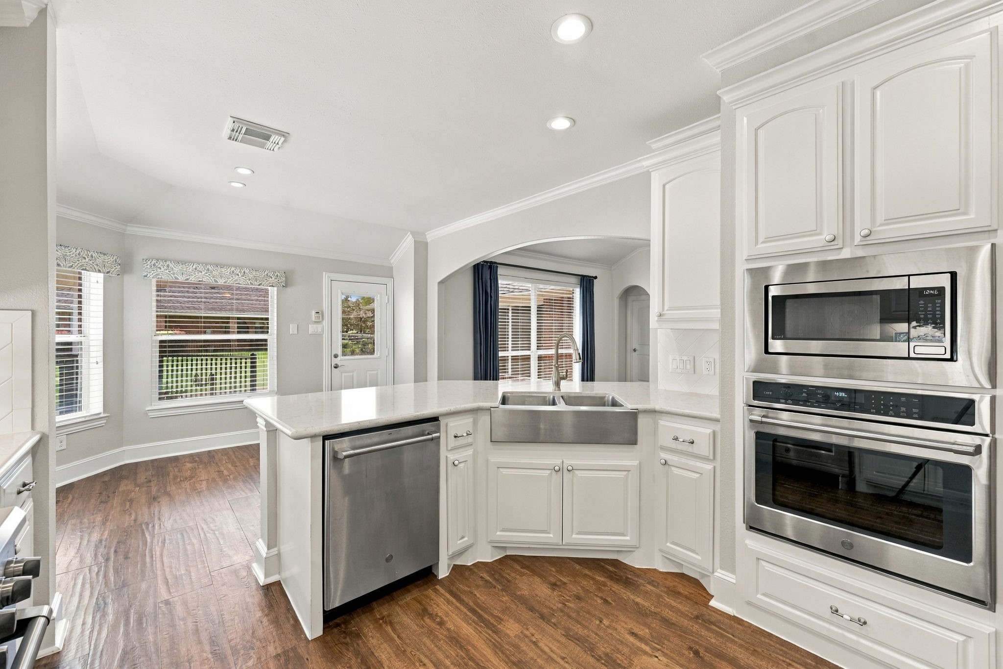 The second oven is a convenient convection electric oven with a microwave above, complemented by additional cabinetry that provides ample storage and keeps the space both functional and organized.