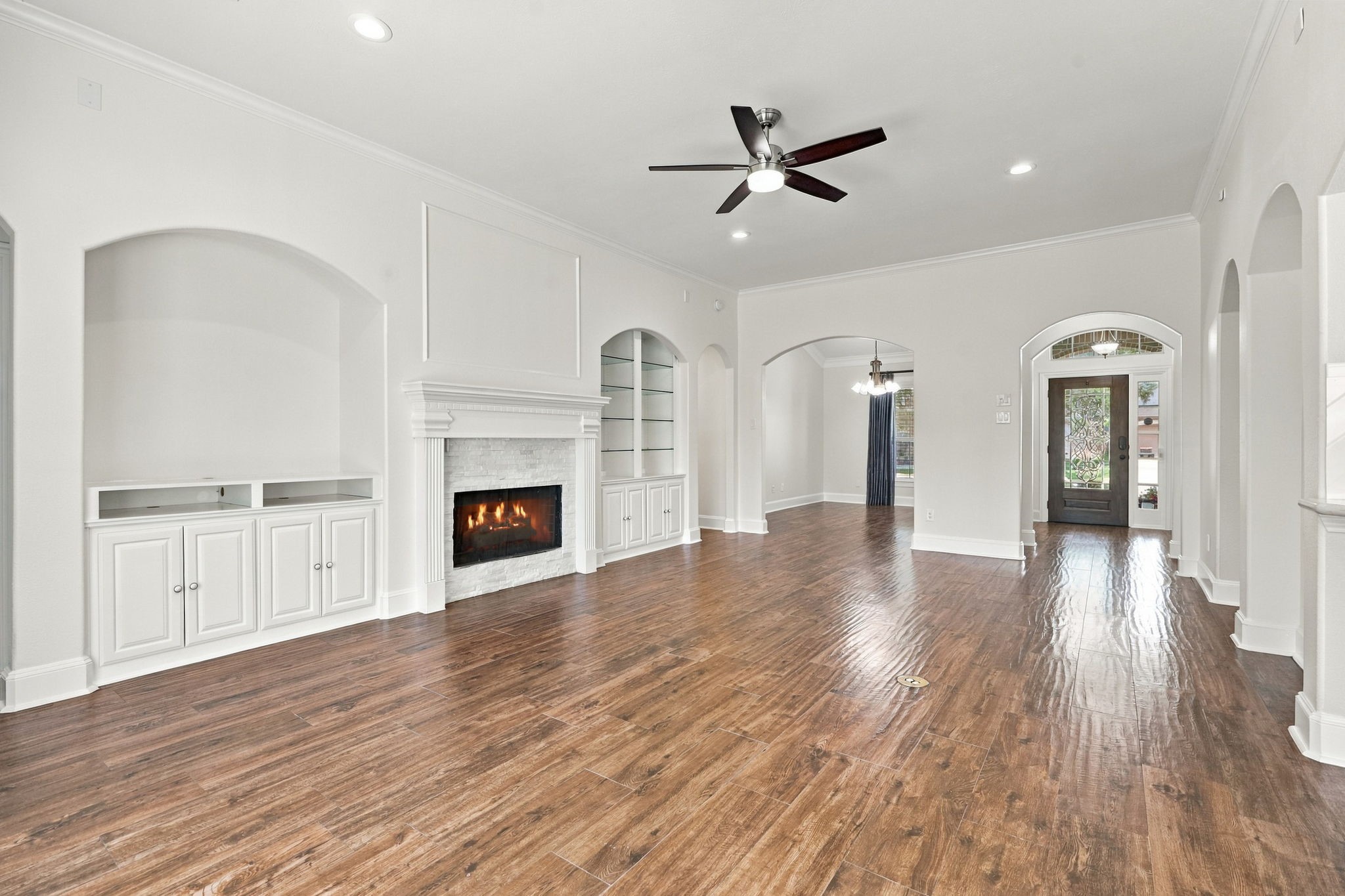Looking in the opposite direction from the Family Room, you get the full picture of this spacious and thoughtfully designed living area, with an easy flow to the Formal Dining room and front entrance. The room is also enhanced by a 5-blade remote-controlled ceiling fan and LED ceiling lighting, adding both comfort and functionality.