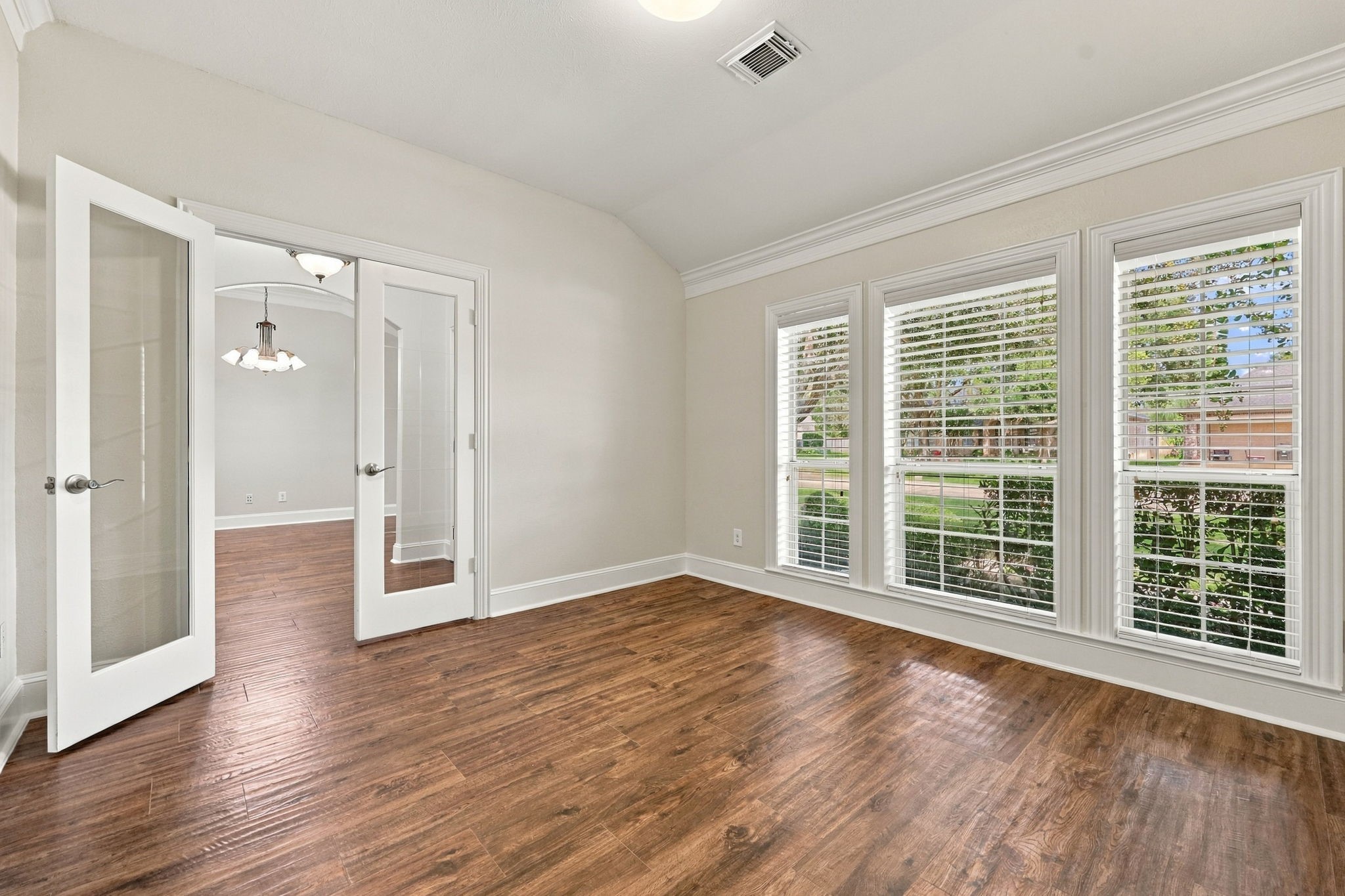 The Home Office is perfect for the executive in the household and is ideally located at the front of the home. This sophisticated space features gorgeous wood-look tile flooring, a wall of windows with 2-inch blinds, elegant crown molding, and beautiful views of the front yard.