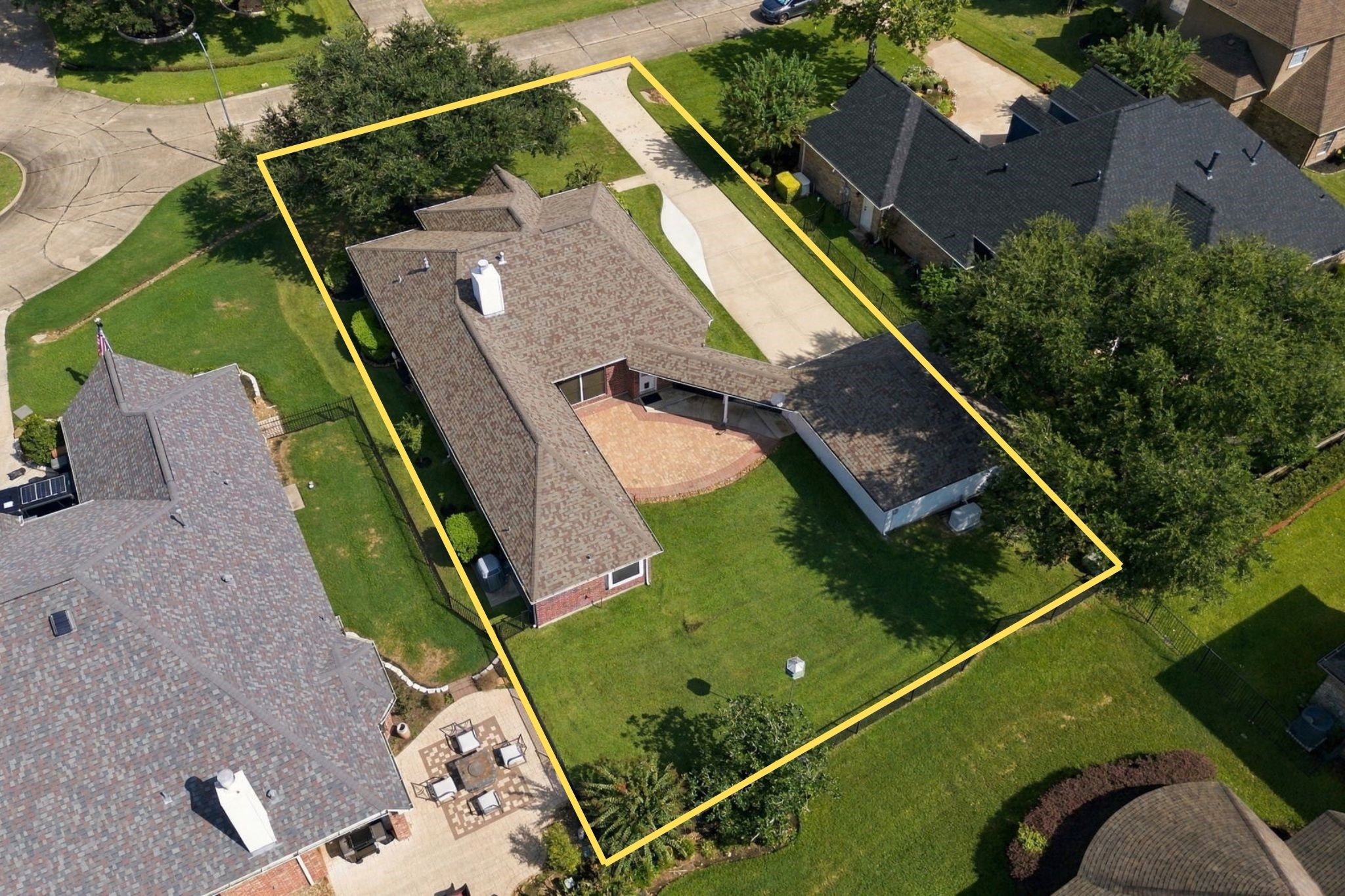 An aerial view showcases how this beautiful home is situated on its oversized 11,021-square-foot lot, highlighting the spacious property, mature landscaping, extended patio, oversized detached garage, and desirable cul-de-sac location. The north/south orientation is an added bonus, helping provide more comfortable outdoor living during our hot Texas summers. Property lines are approximate and are not guaranteed.