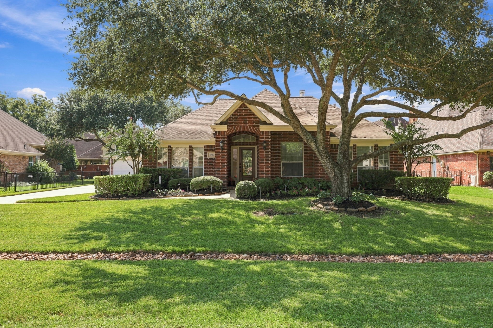 Welcome to 33211 Woodton Ct., beautifully situated in the prestigious, gated golf community of Weston Lakes. This gorgeous one-story brick home makes an impressive first impression with its distinctive gable roofline, beautifully manicured landscaping, and serene setting beneath a majestic mature pecan tree. The inviting curb appeal sets the tone for the warmth and elegance youll find throughout this exceptional home.