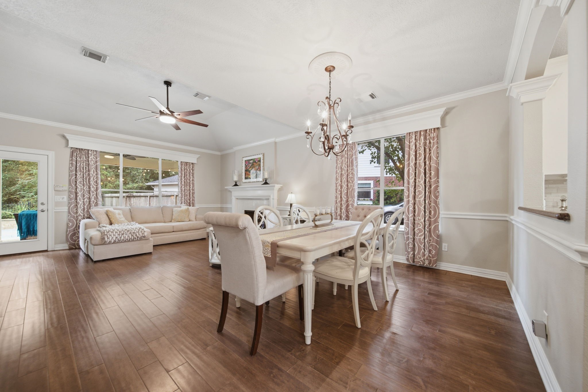 Beautiful wood floor, crown molding, and custom trim around the windows add character to this inviting living and dining space. The owners thoughtfully opened up the kitchen to the living room, enhancing the original floor plan with a connection ideal for everyday living and entertaining.