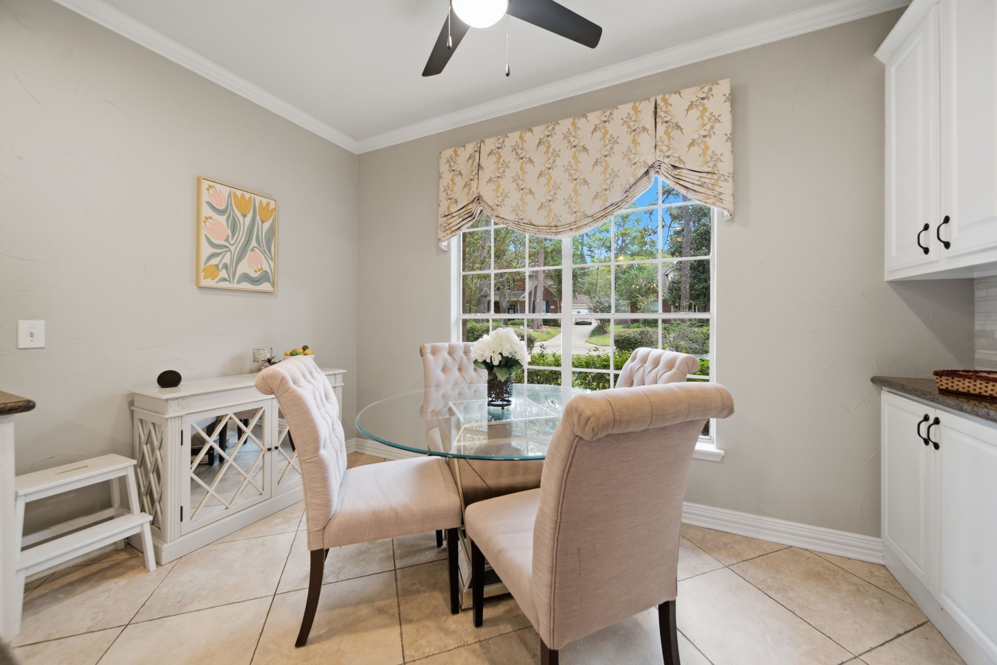 This bright breakfast room is such a comfortable space to start the day or just to visit with your friends and family. Additional cabinetry has been added to this kitchen/breakfast area for valuable storage space.