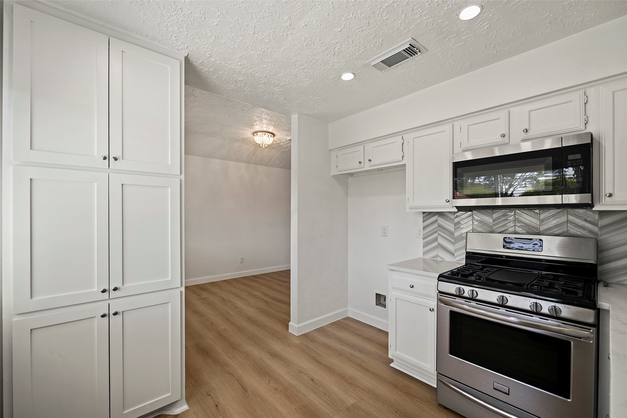 Functional layout with generous cabinet and counter space along with a pantry