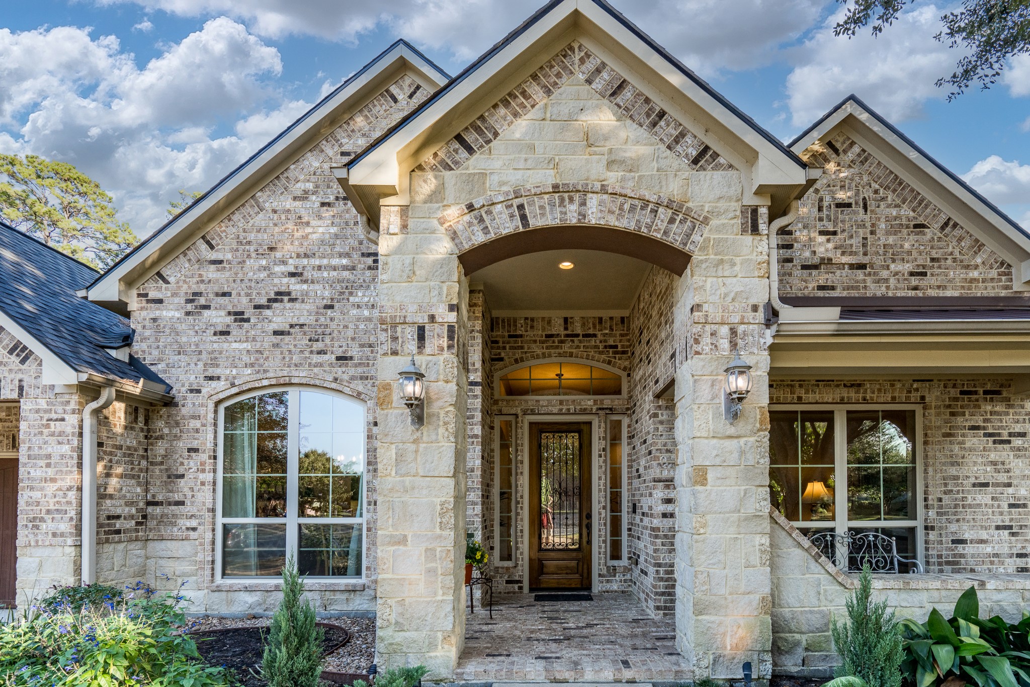 SOME HOMES CAPTURE YOUR ATTENTION THIS ONE CAPTURES YOUR HEART! From the moment you approach this exquisite J. Patrick semi-custom home, you'll be captivated by its timeless beauty and extraordinary craftsmanship. Intricate decorative brickwork, rich stone accents, and a magnificent arched entryway create a breathtaking architectural statement. Every thoughtfully designed detail offers a glimpse of the elegance, warmth, and exceptional lifestyle awaiting just beyond the front door!