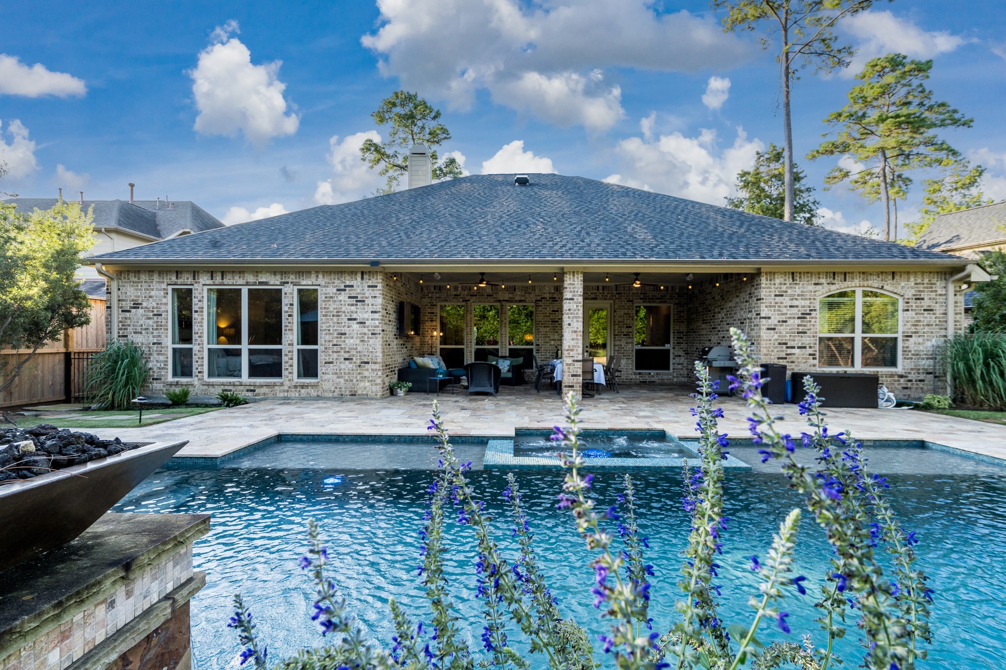 A Picture-Perfect Backyard Paradise! Peek through the colorful blooms to discover your own private resort-style oasis, featuring a sparkling swimming pool, inviting spa, and expansive covered patio designed for year-round entertaining. The recently installed roof adds lasting value and peace of mind to this exceptional luxury retreat. Every day feels like a vacation in your own backyard!