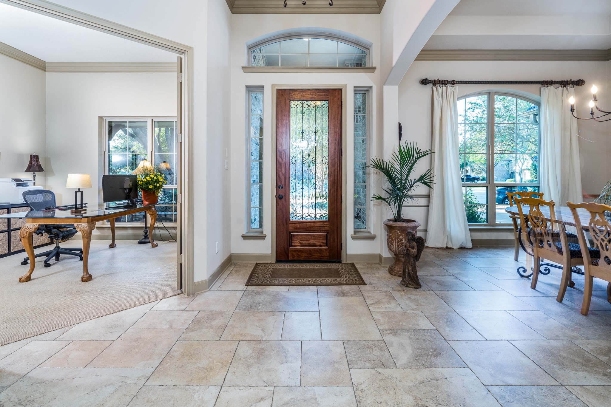 A GRAND ENTRANCE TO ELEGANT LIVING! Step inside this stunning J. Patrick semi-custom home, where soaring ceilings, beautiful tumbled travertine flooring, and abundant natural light create an unforgettable first impression. A sophisticated private study welcomes you on the left, while the elegant formal dining room awaits on the rightperfectly positioned for both productive days and memorable celebrations. Timeless architectural details and an inviting open design set the stage for luxury living!