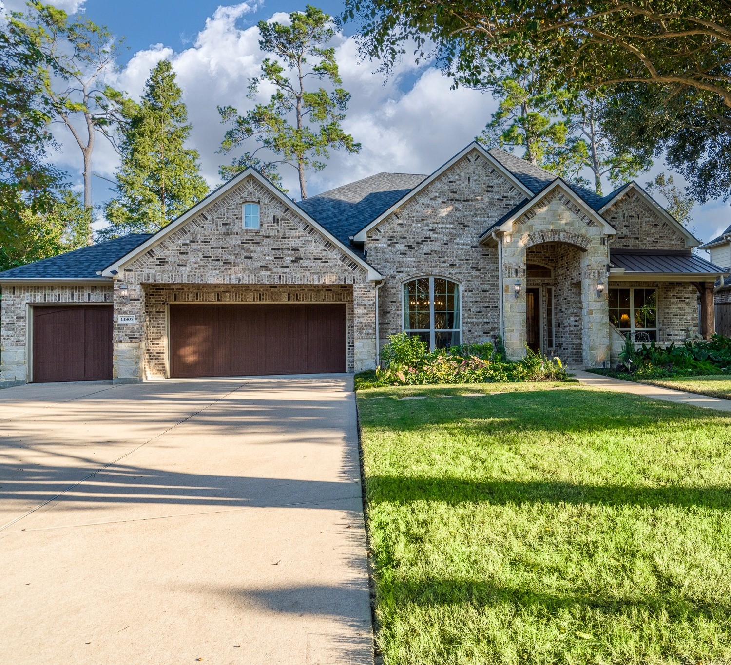 Notice the gorgeous architectural detail of the intricate brickwork on this semi custom J. Patrick one story and the mature professional landscaping. This home has a covered front porch too!
