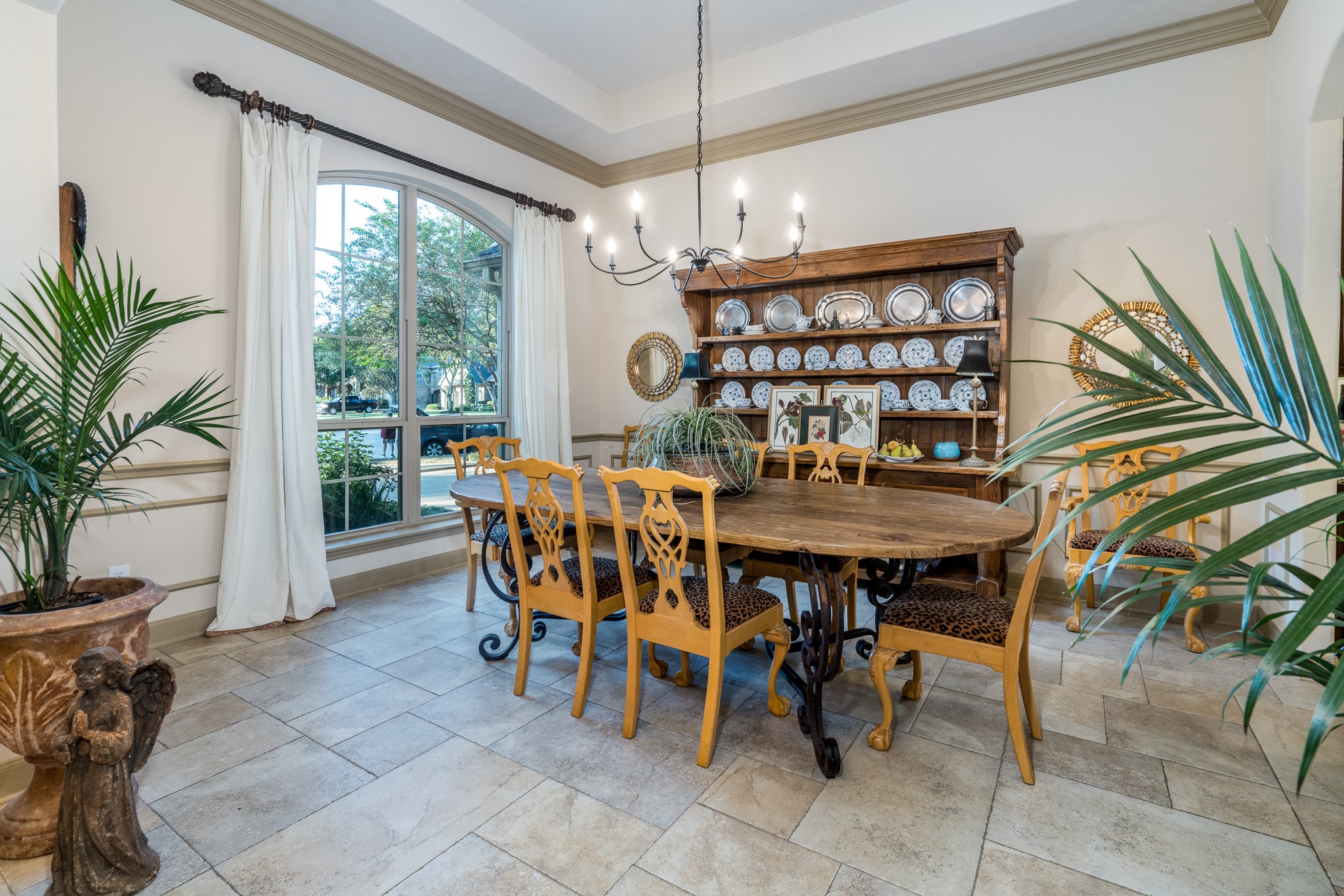 WHERE BEAUTIFUL MEMORIES ARE MADE! This elegant formal dining room sets the stage for unforgettable gatherings, featuring soaring ceilings, graceful architectural details, and expansive windows that fill the space with natural light. Whether hosting festive celebrations or intimate dinners, this sophisticated setting brings warmth, timeless elegance, and a touch of luxury to every occasion!