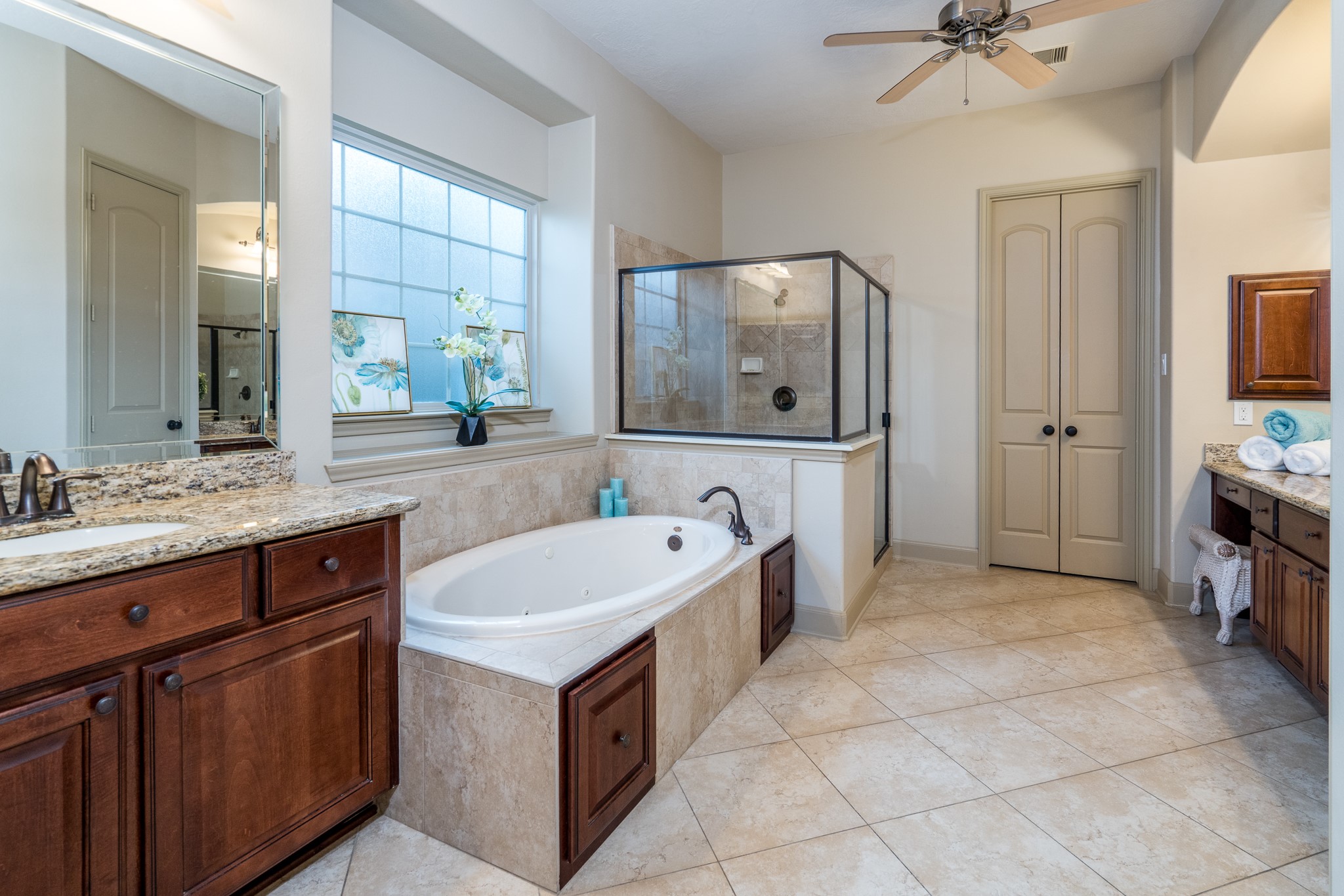 YOUR PERSONAL SANCTUARY OF PEACE AND INDULGENCE! Imagine escaping the demands of the day and slipping into a luxurious soaking tub, surrounded by beautiful natural stone finishes and soft, natural light. This spacious, spa-inspired primary ensuite features a stunning walk-in shower, elegant granite vanities, and an atmosphere designed for complete relaxation. Because true luxury is having a beautiful place to unwind, recharge, and feel completely at home!