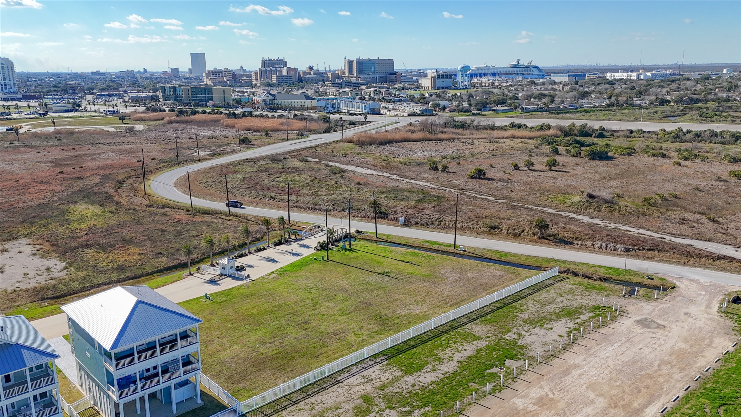 This sweeping aerial view places The Preserve at Grand Beach within Galvestons East End and shows the open landscape extending toward the islands historic core. The setting offers an appealing combination: a secluded gated coastal community with beach access and Gulf views, yet only minutes from The Strand, restaurants, shopping and Galveston attractions. It is an exceptional location for a full-time residence, second home or coastal retreat.