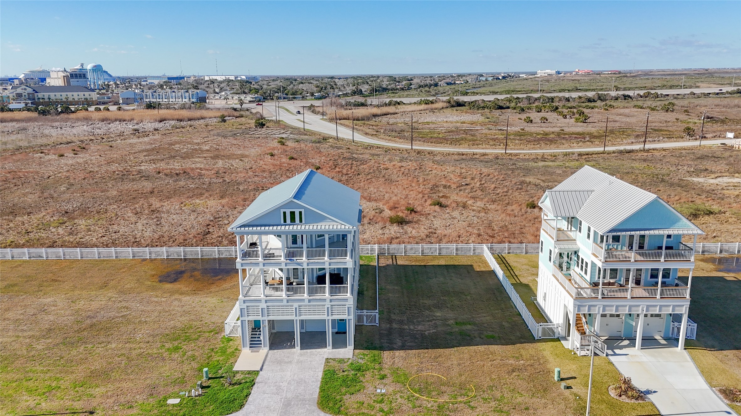 This view from the rear illustrates one of the propertys most distinctive advantages: an unusually open setting behind the homesite with no immediate rear neighbor. That unobstructed exposure creates opportunities to orient decks, balconies and outdoor living areas toward expansive western views and colorful Galveston sunsets, while the opposite side of a future residence can be designed to capitalize on sunrise views toward the Gulf. This view from the rear illustrates one of the propertys most distinctive advantages: an unusually open setting behind the homesite with no immediate rear neighbor. That unobstructed exposure creates opportunities to orient decks, balconies and outdoor living areas toward expansive western views and colorful Galveston sunsets, while the opposite side of a future residence can be designed to capitalize on sunrise views toward the Gulf.