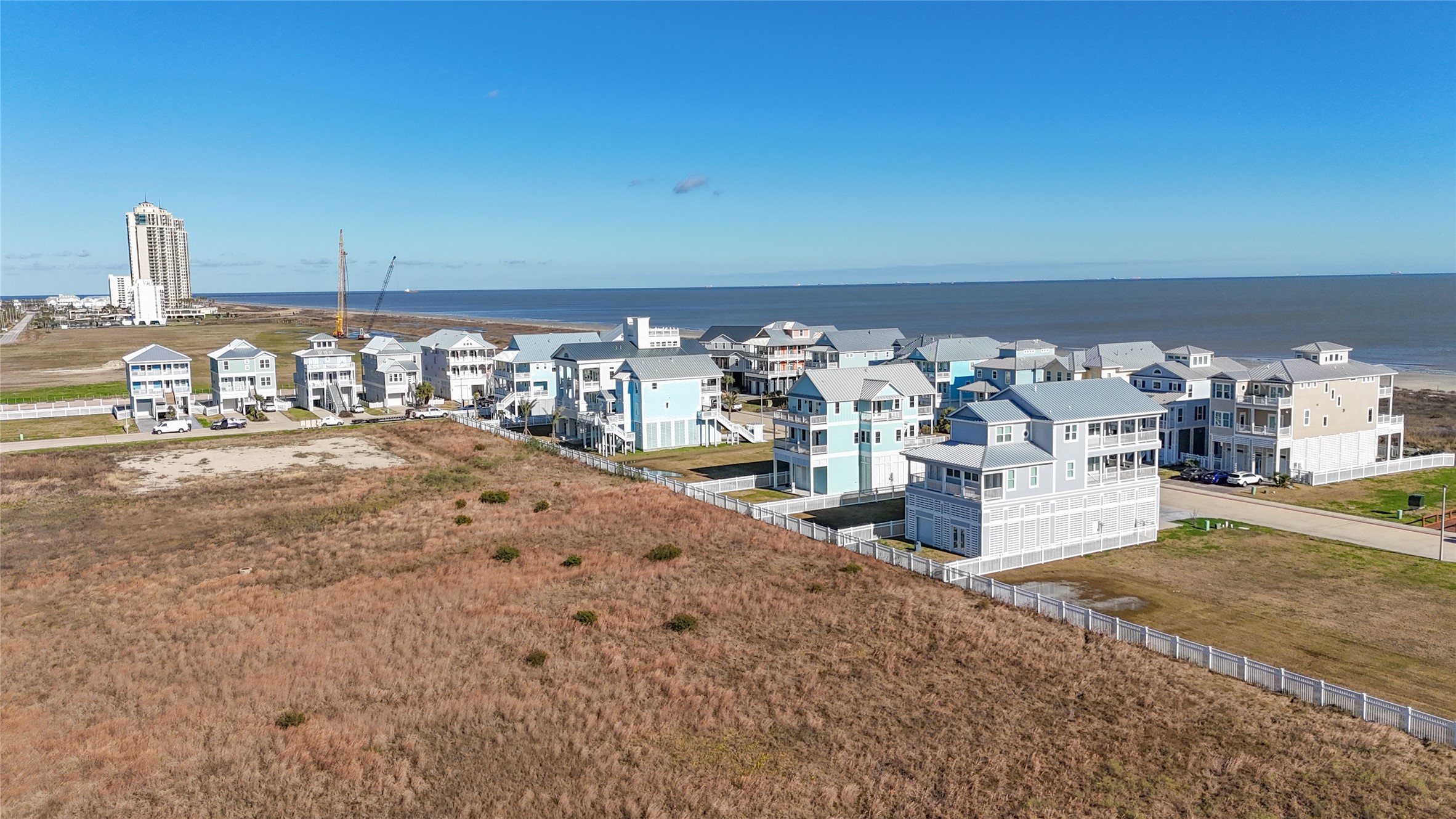 Aerial view shows the homesite in relation to the surrounding East End landscape, with the Gulf and established Preserve at Grand Beach residences nearby. Unlike many densely developed Galveston building sites, this property benefits from an open rear exposure with no back neighbor. The combination creates the potential for a custom home designed around views in both directionsGulf sunrises to the east and expansive sunsets to the west. Aerial view shows the homesite in relation to the surrounding East End landscape, with the Gulf and established Preserve at Grand Beach residences nearby. Unlike many densely developed Galveston building sites, this property benefits from an open rear exposure with no back neighbor. The combination creates the potential for a custom home designed around views in both directionsGulf sunrises to the east and expansive sunsets to the west.