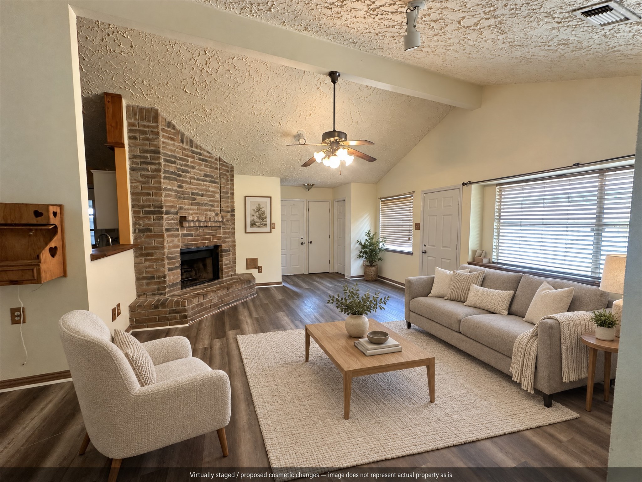 Virtually staged. A cozy seating arrangement highlights the brick fireplace and open living space. Virtually staged. A cozy seating arrangement highlights the brick fireplace and open living space.