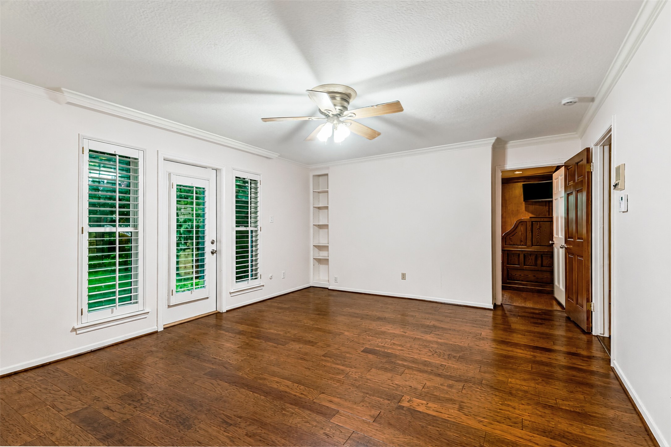 Primary bedroom with private outdoor access and direct access to home office/study.