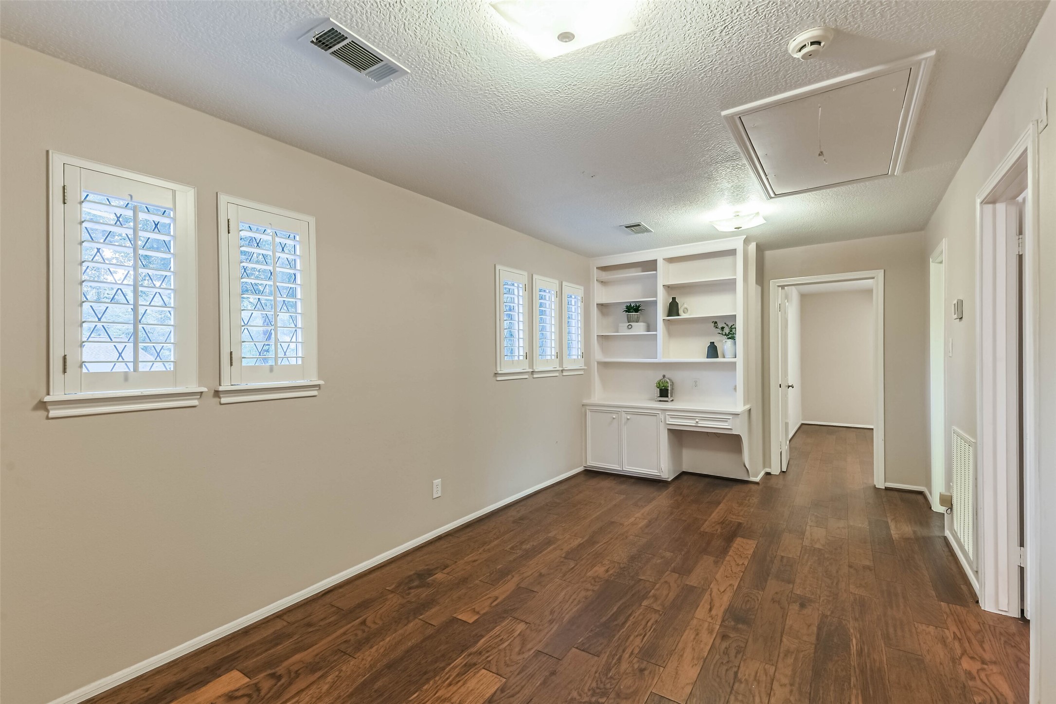 Upstairs hallway/playroom, with built in desk and shelves.
