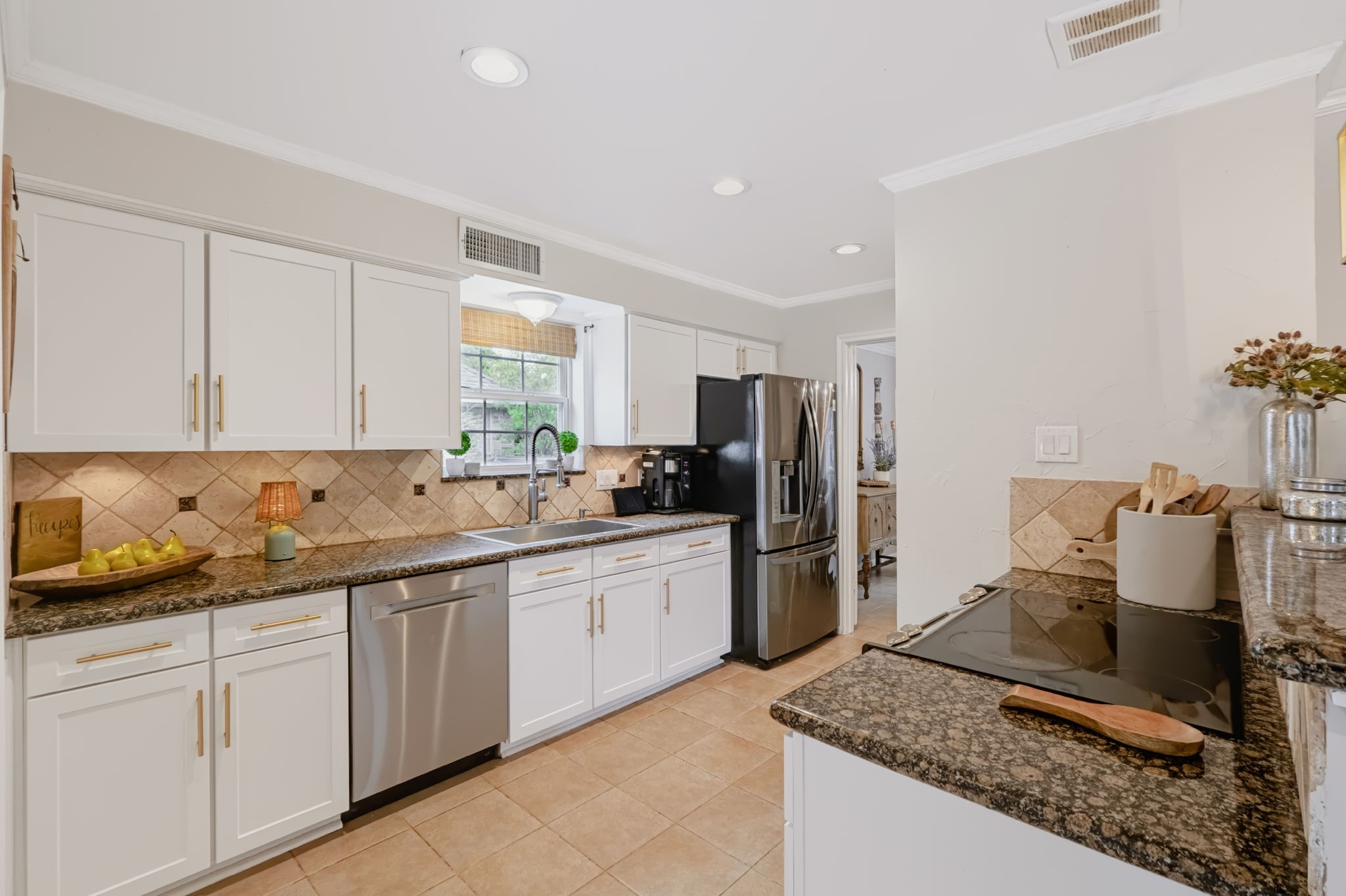 Spacious kitchen offering extensive upper and lower cabinetry, generous preparation surfaces, and a practical layout designed for everyday cooking and entertaining.