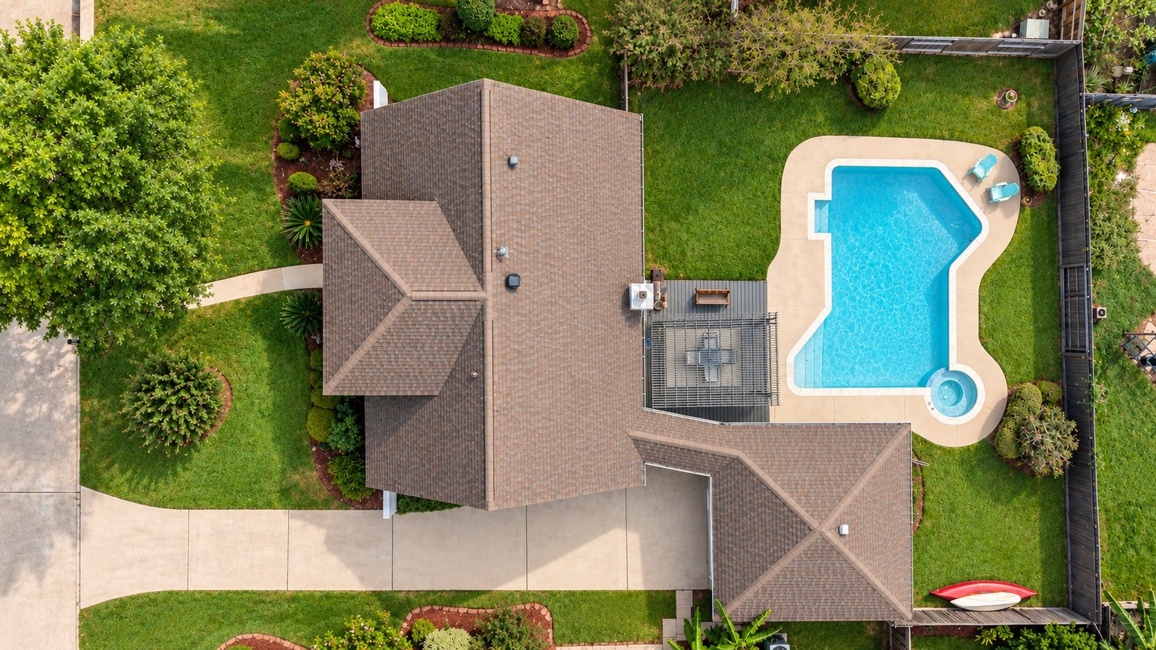 Overhead aerial view highlighting the property layout, backyard, and pool.