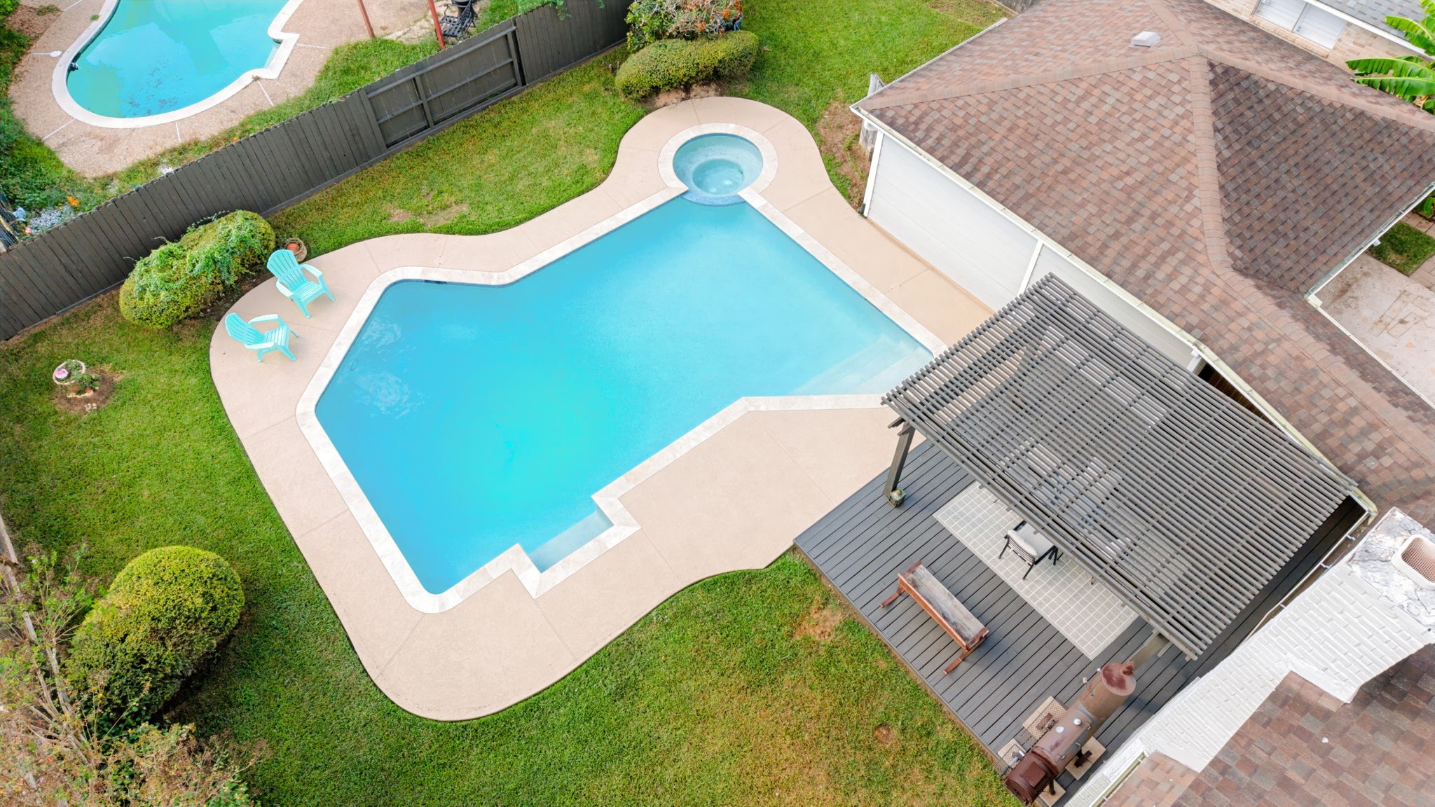 Aerial view of the recently redone pool, updated pool area, and new deck.