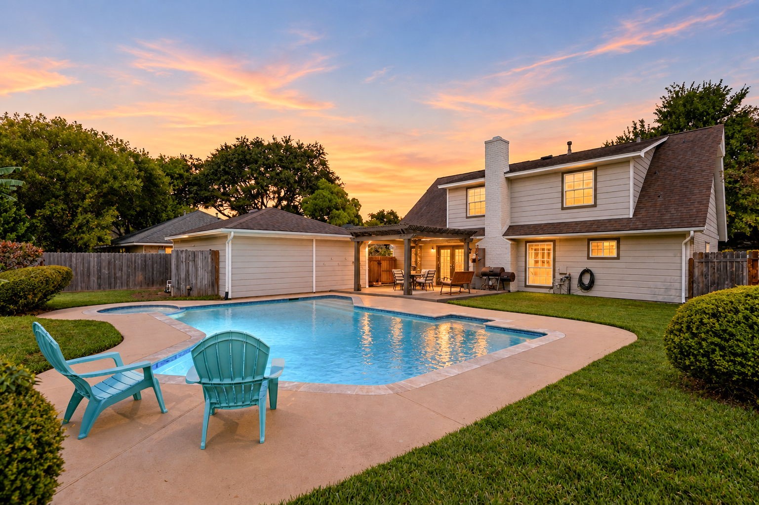 Sunset view of the recently redone pool and beautifully maintained backyard.
