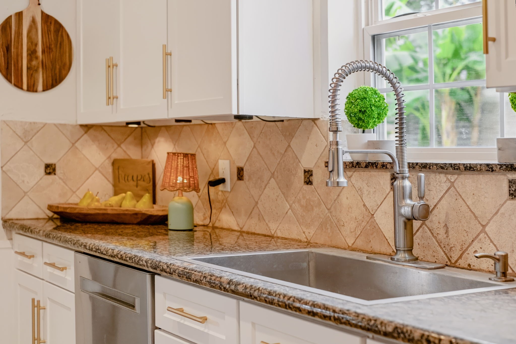 Detailed view of the kitchen sink area and surrounding workspace.