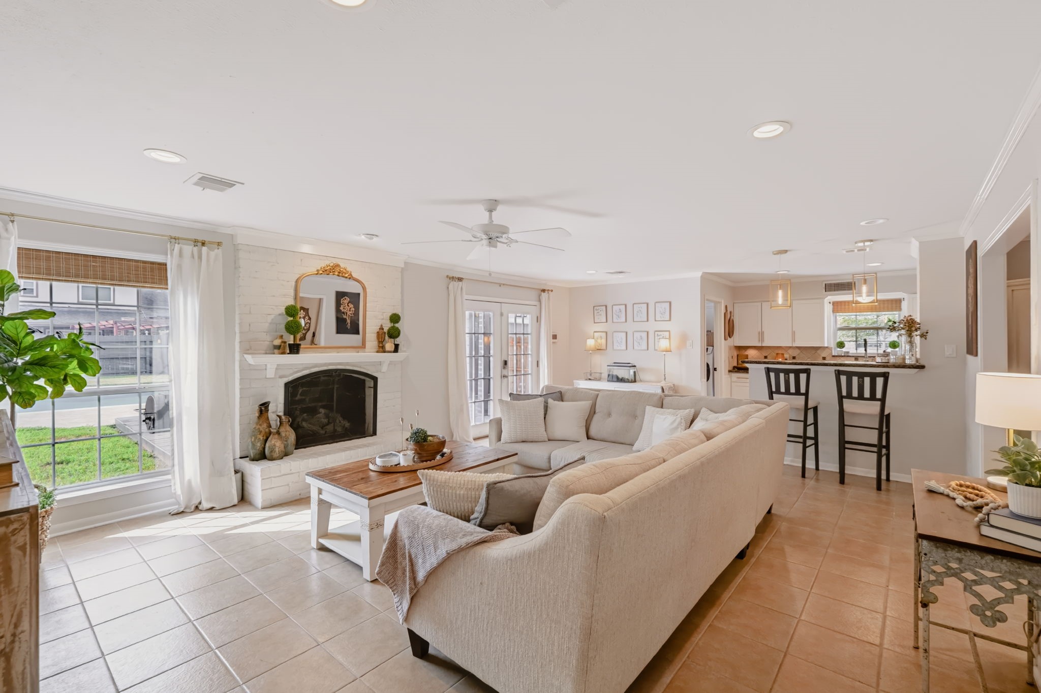 Spacious open-concept living area with abundant natural light and a fireplace. Spacious open-concept living area with abundant natural light and a fireplace.