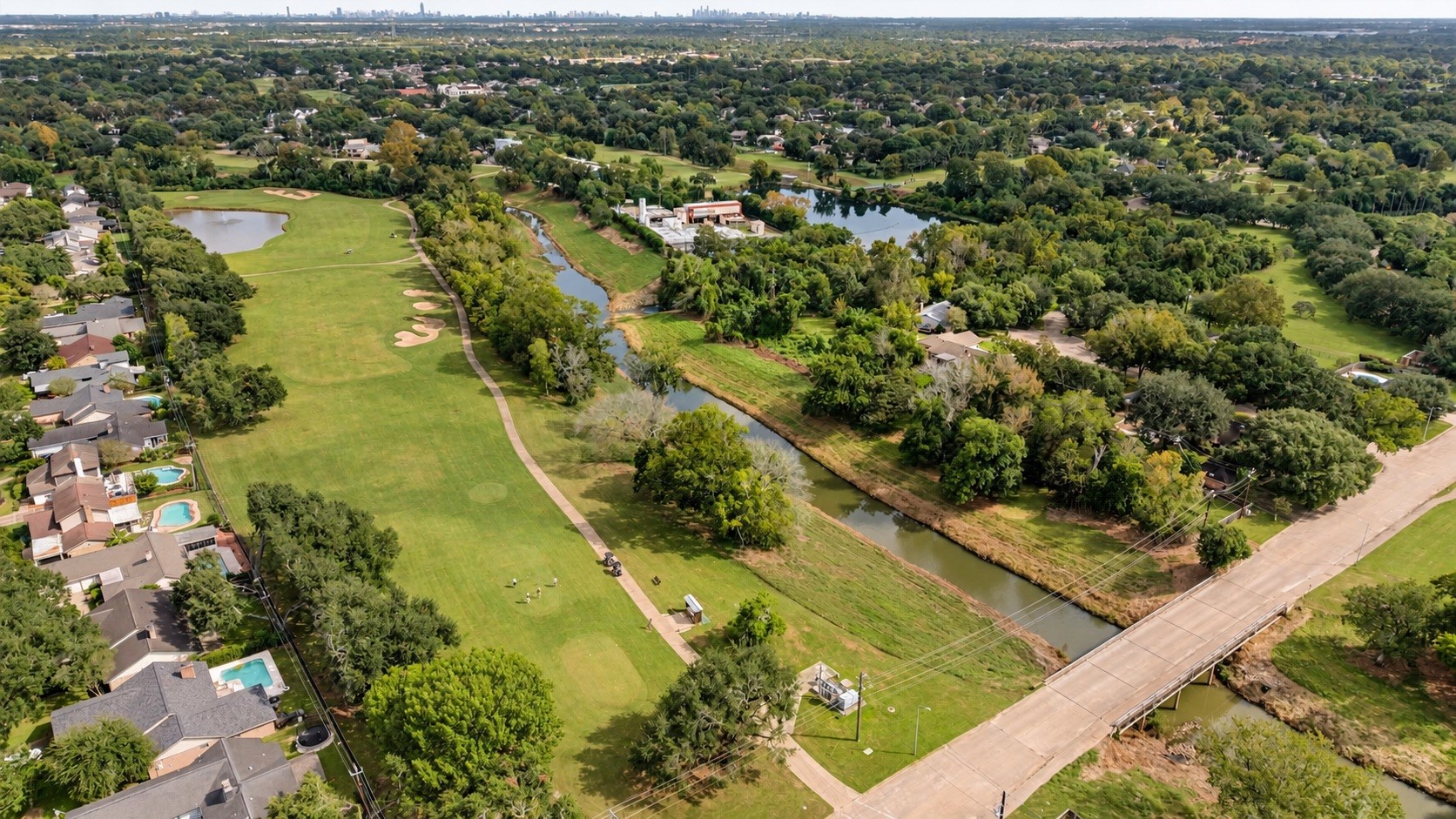 Expansive aerial view showcasing the surrounding community and nearby green space.