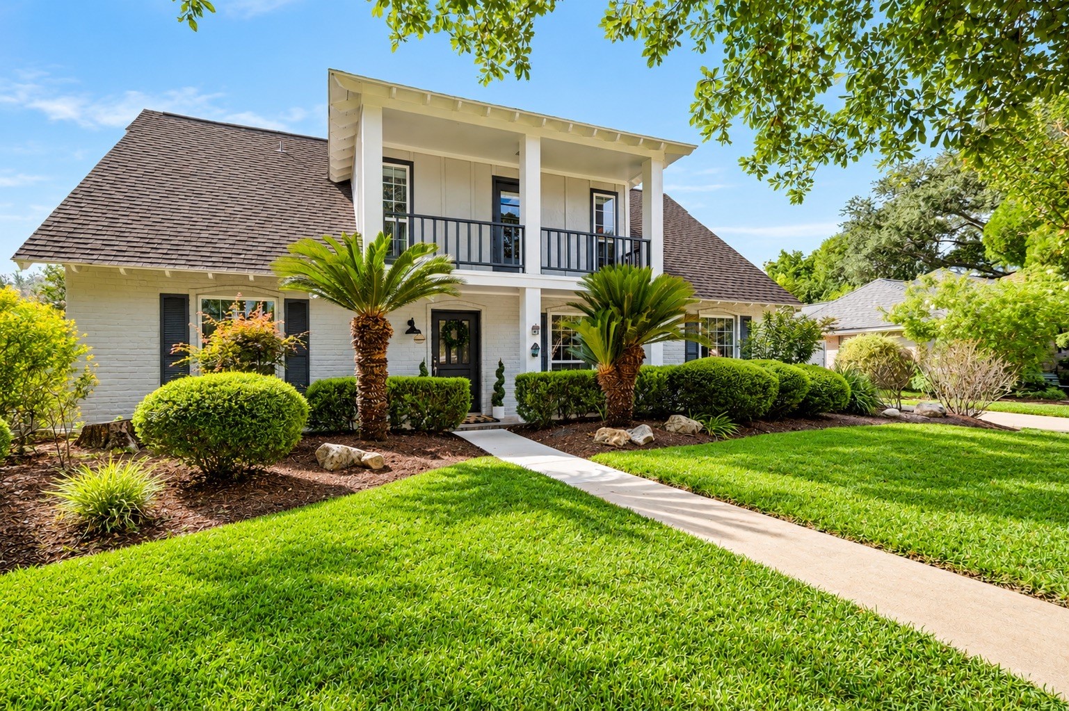 Impressive front exterior with manicured landscaping, recent paint, and new Hardie plank siding.