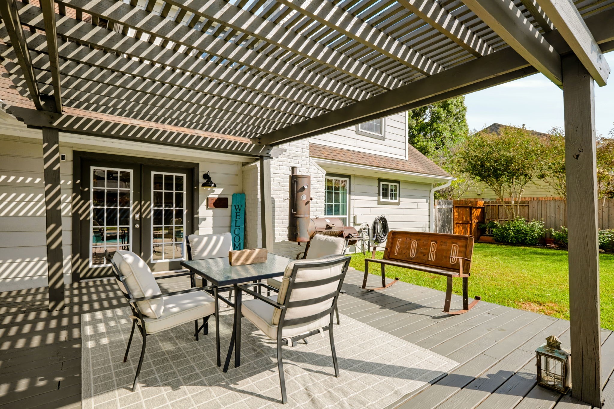 Enjoy outdoor relaxation and entertaining beneath the new covered deck, offering a shaded gathering space just steps from the beautifully refreshed pool.
