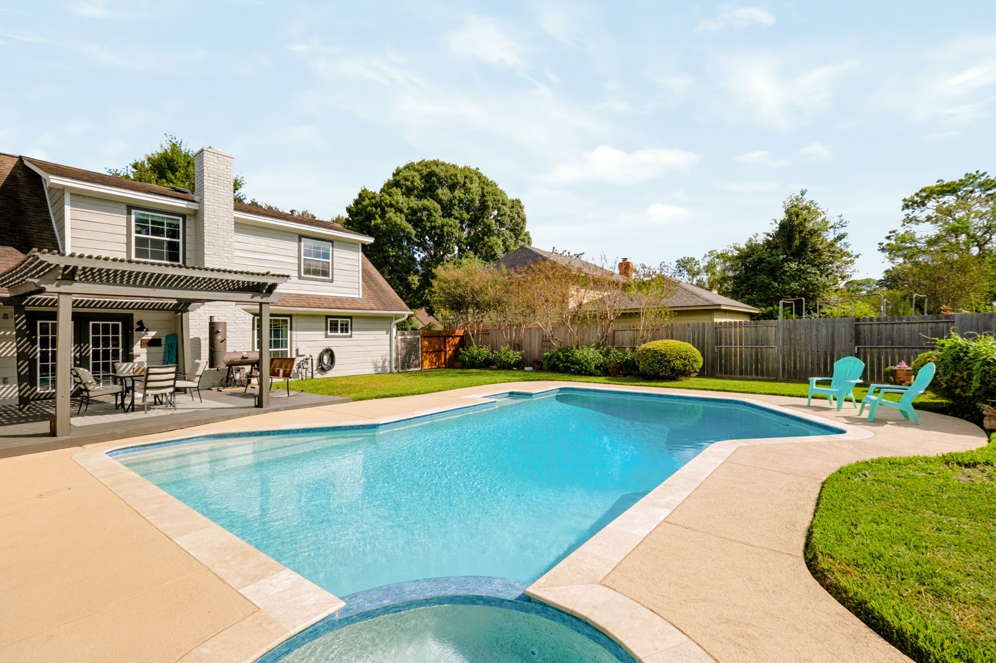 Backyard retreat featuring a recently redone pool, updated equipment, and generous outdoor space.