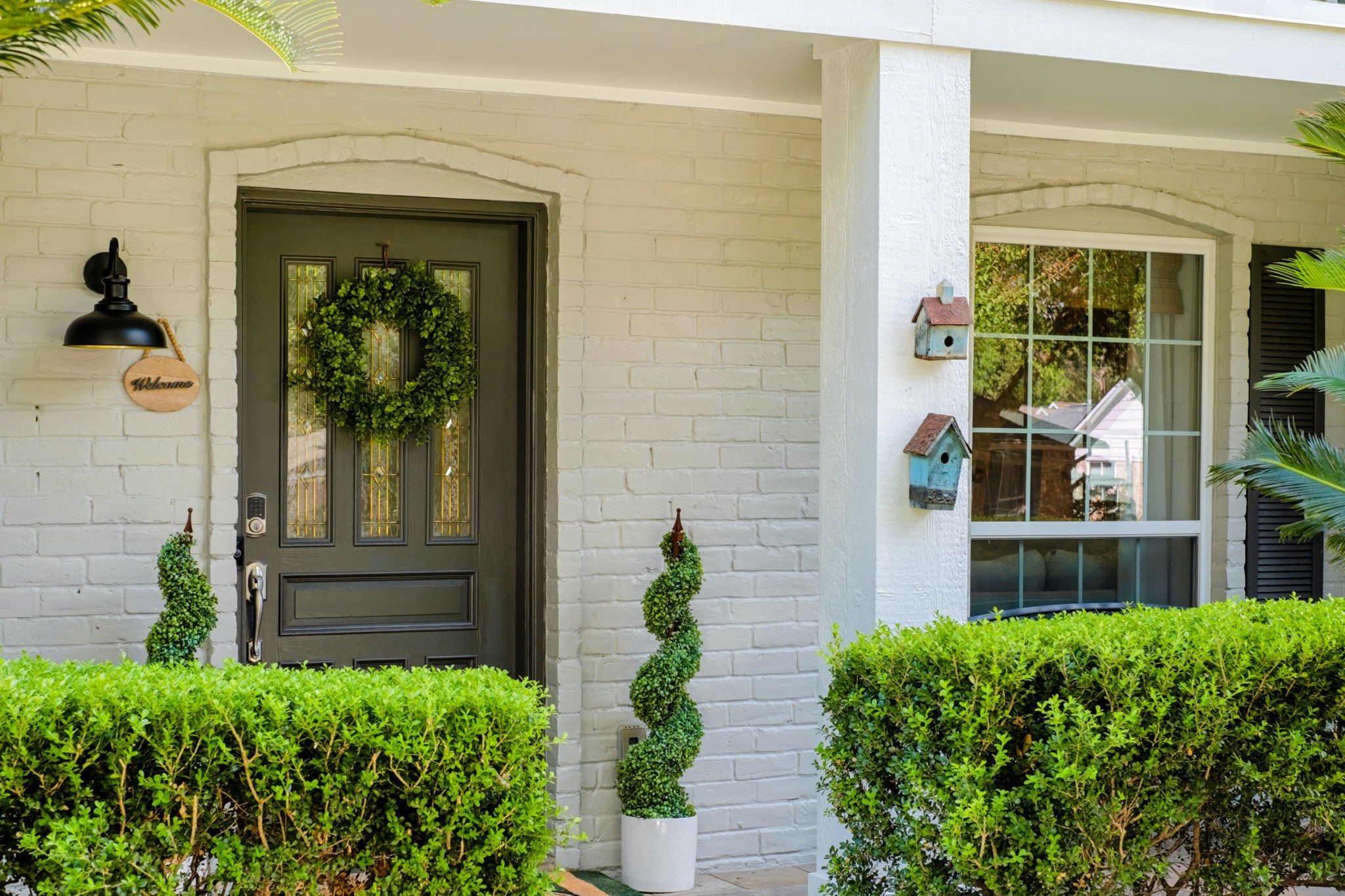 Covered front entry framed by neatly maintained landscaping. Covered front entry framed by neatly maintained landscaping.