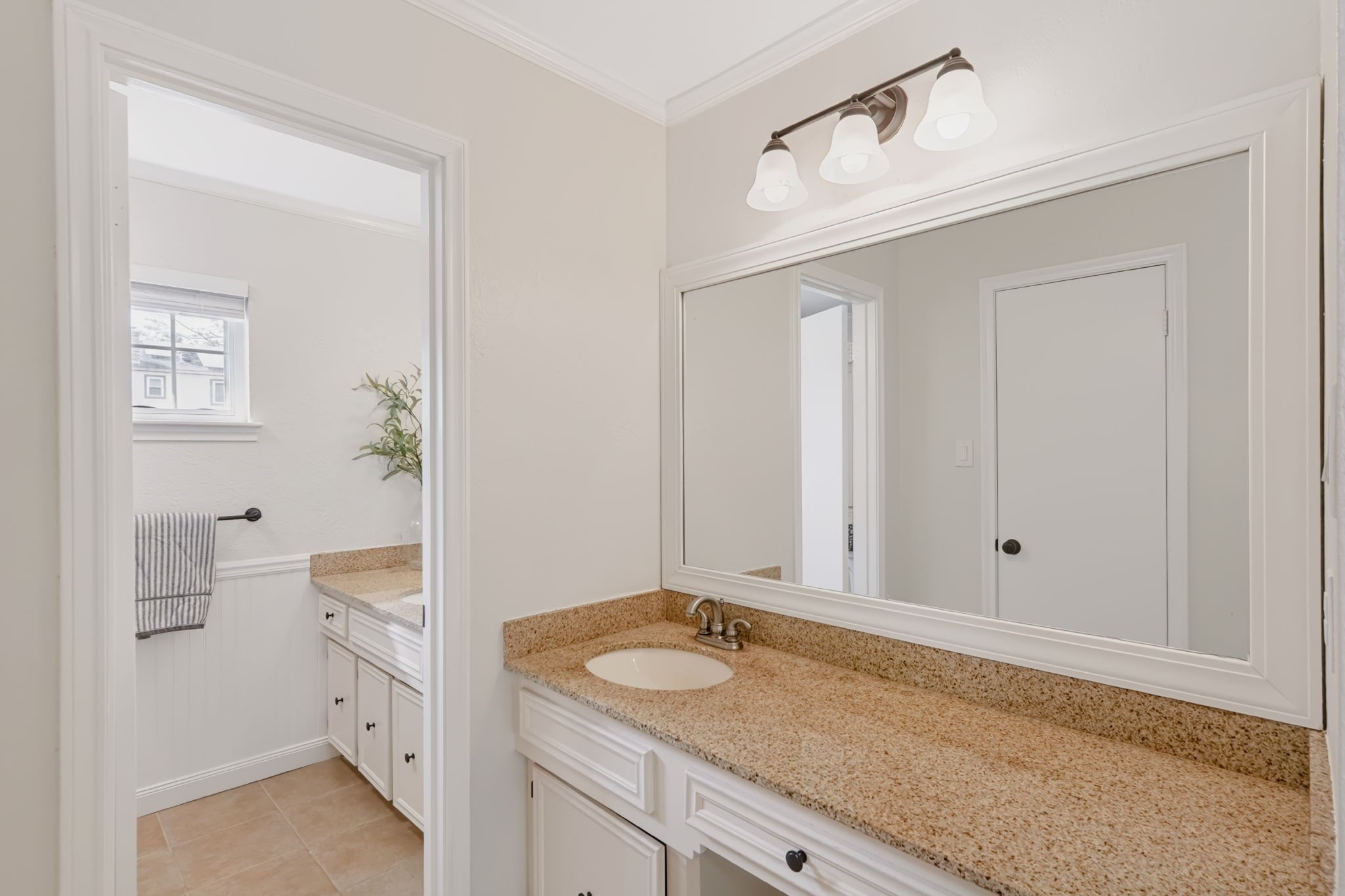 Primary bathroom vanity area with generous counter space.