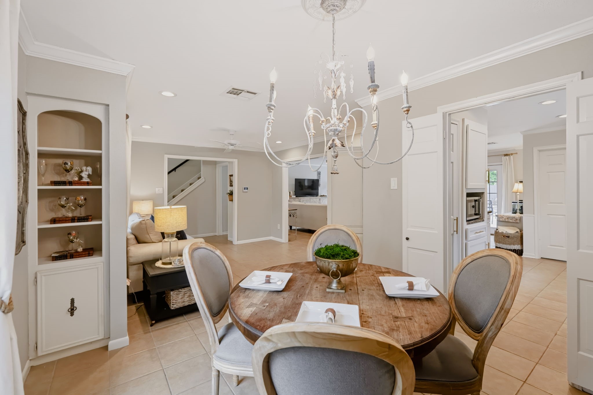 Formal dining area featuring built-in display storage and an updated light fixture.