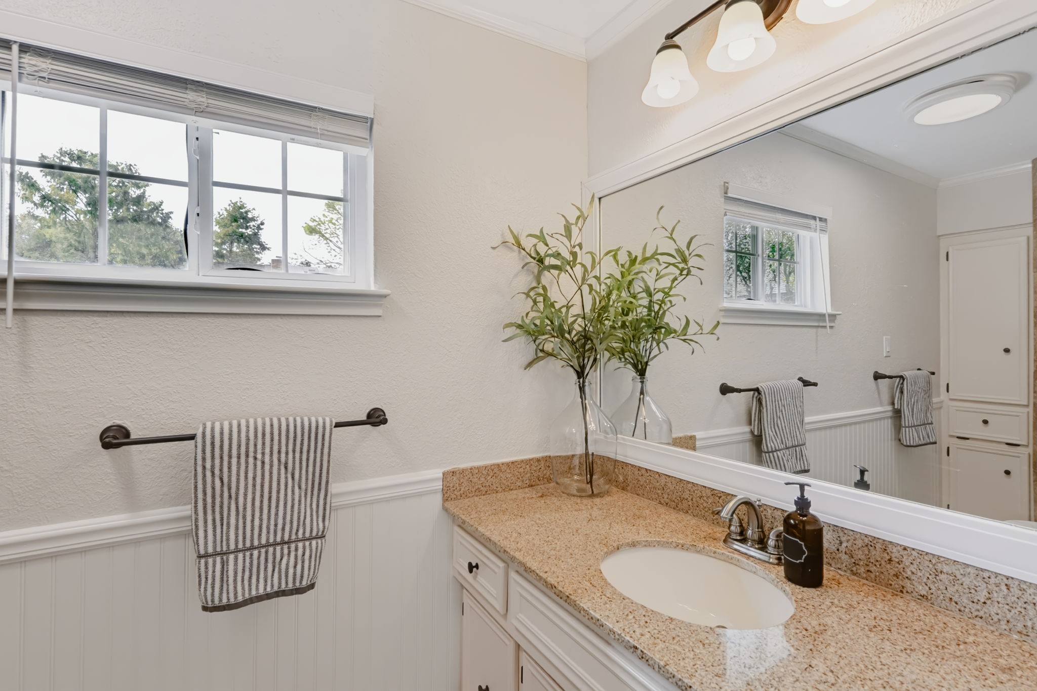 Full bathroom with a large vanity and shower/tub combination.