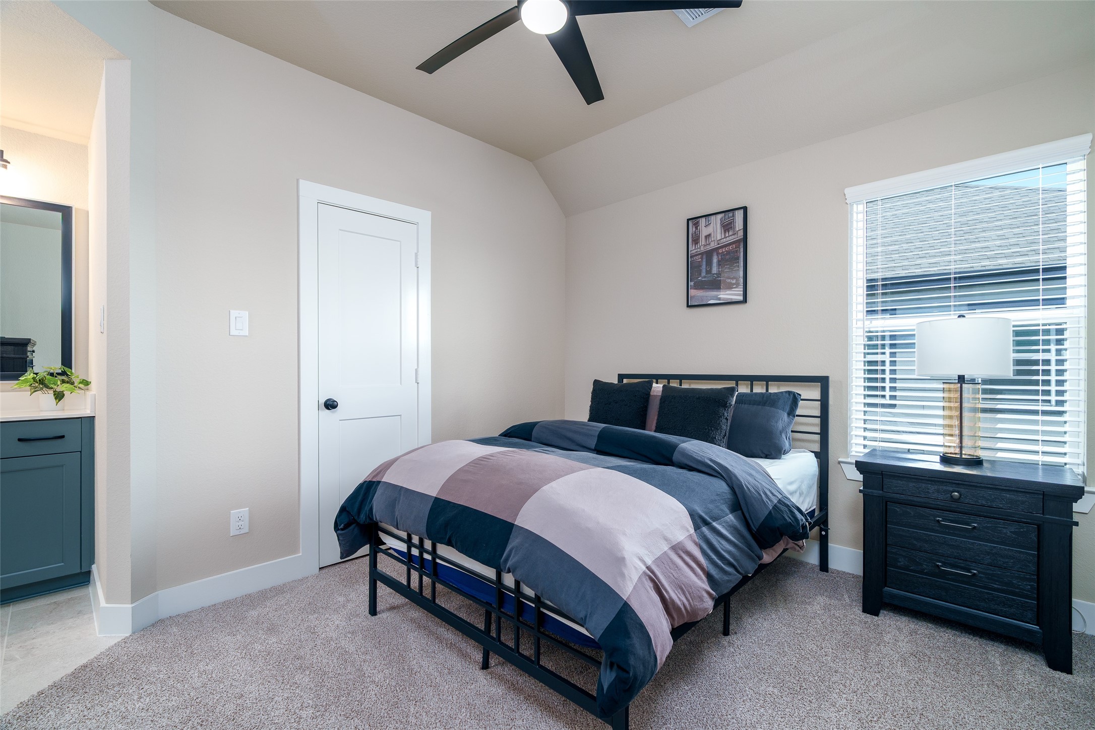 This bedroom features the convenience of a private sink and direct access to a shared bathroom, offering both privacy and functionality.