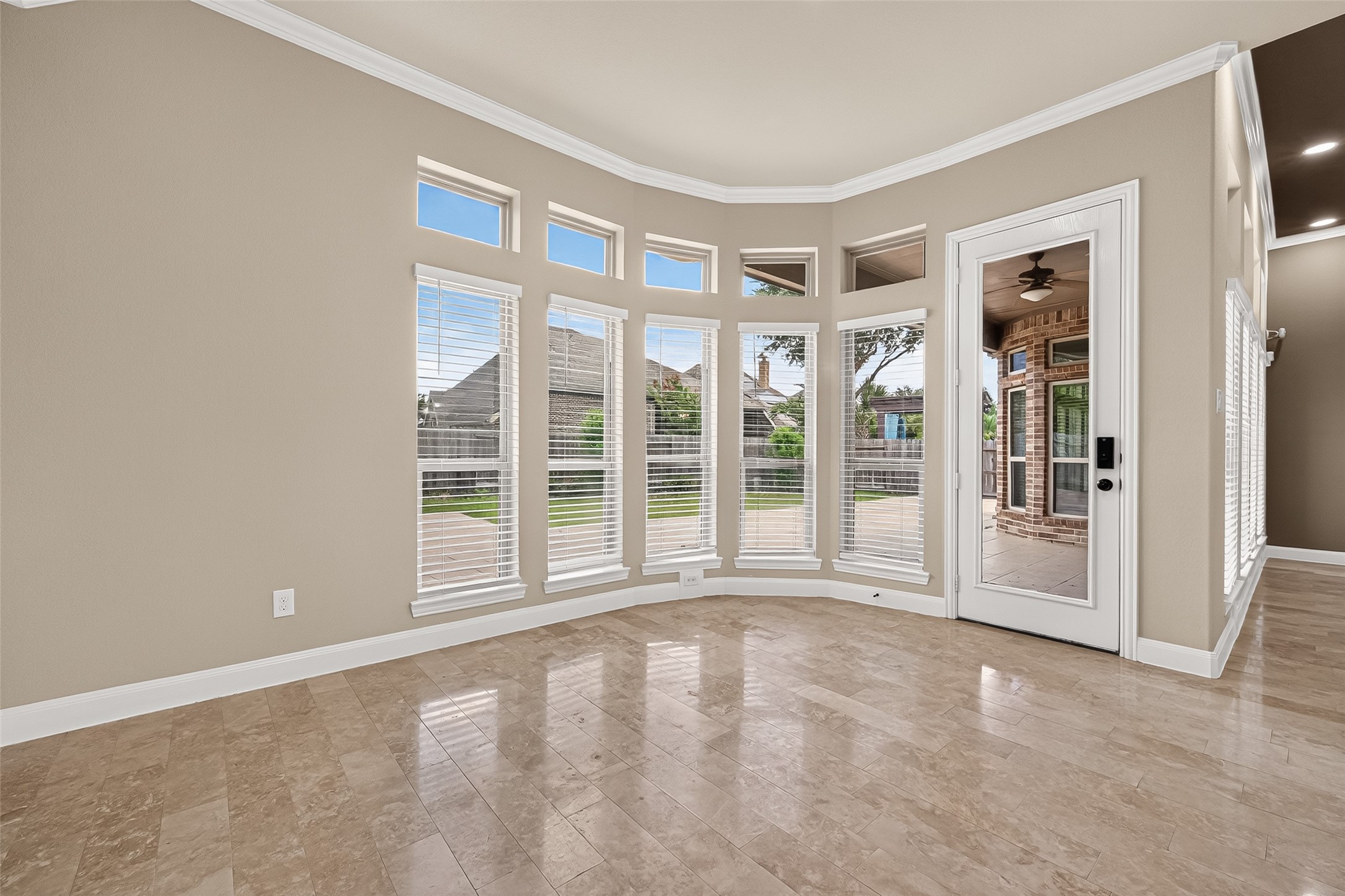 Breakfast Area: The adjoining breakfast area is surrounded by a graceful curved wall of windows overlooking the backyard.