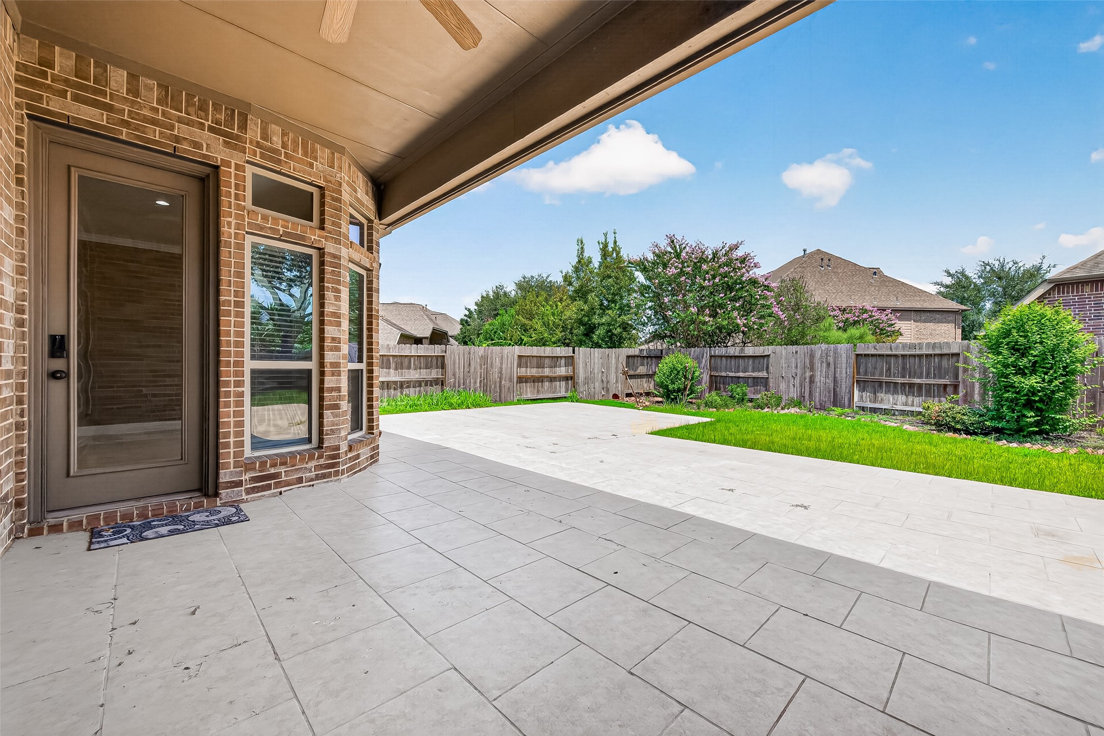 Step outside to a generously sized backyard designed for low-maintenance living and entertaining, complete with extended stone pavers that create the perfect outdoor gathering space.