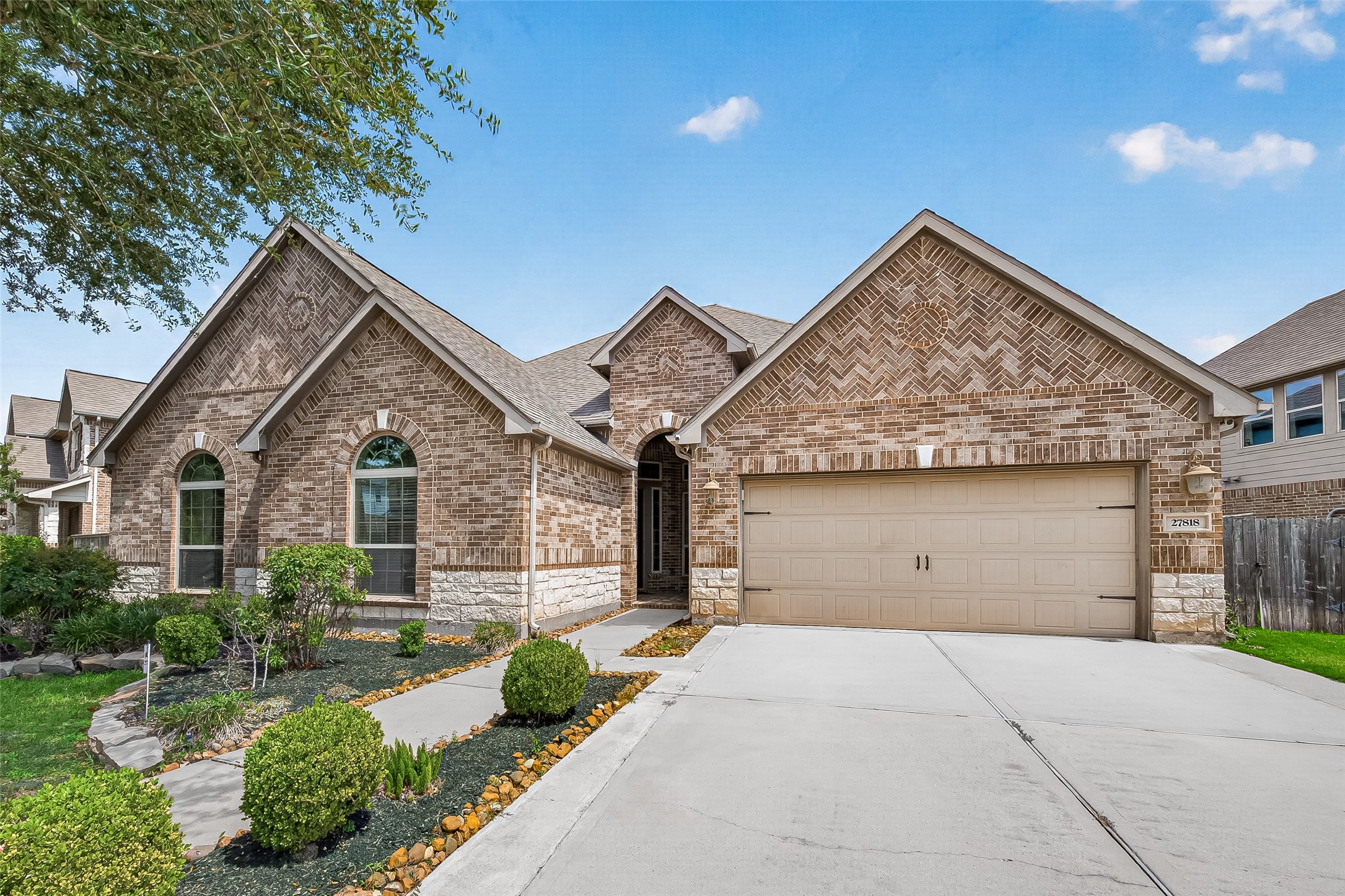 Nestled in the highly sought-after Cinco Ranch community, this stunning 1.5-story home showcases exceptional curb appeal with a beautiful stone elevation, lush landscaping, and architectural details that create a lasting first impression. A welcoming front porch with elegant dual wood front doors featuring wrought iron detailing sets the tone for the sophistication found throughout.