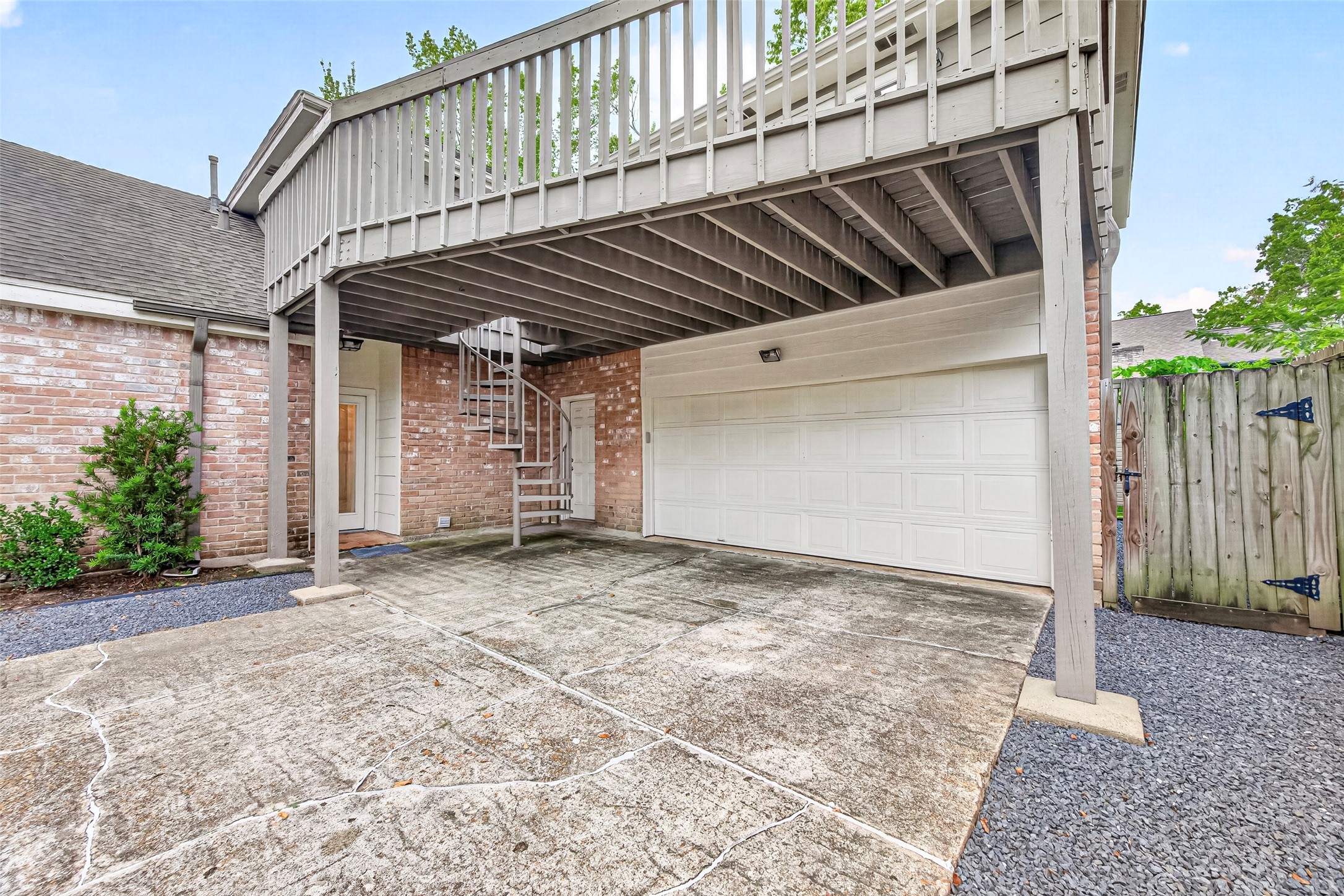 Attached garage and covered parking. Notice the circular staircase that takes you to the balcony.