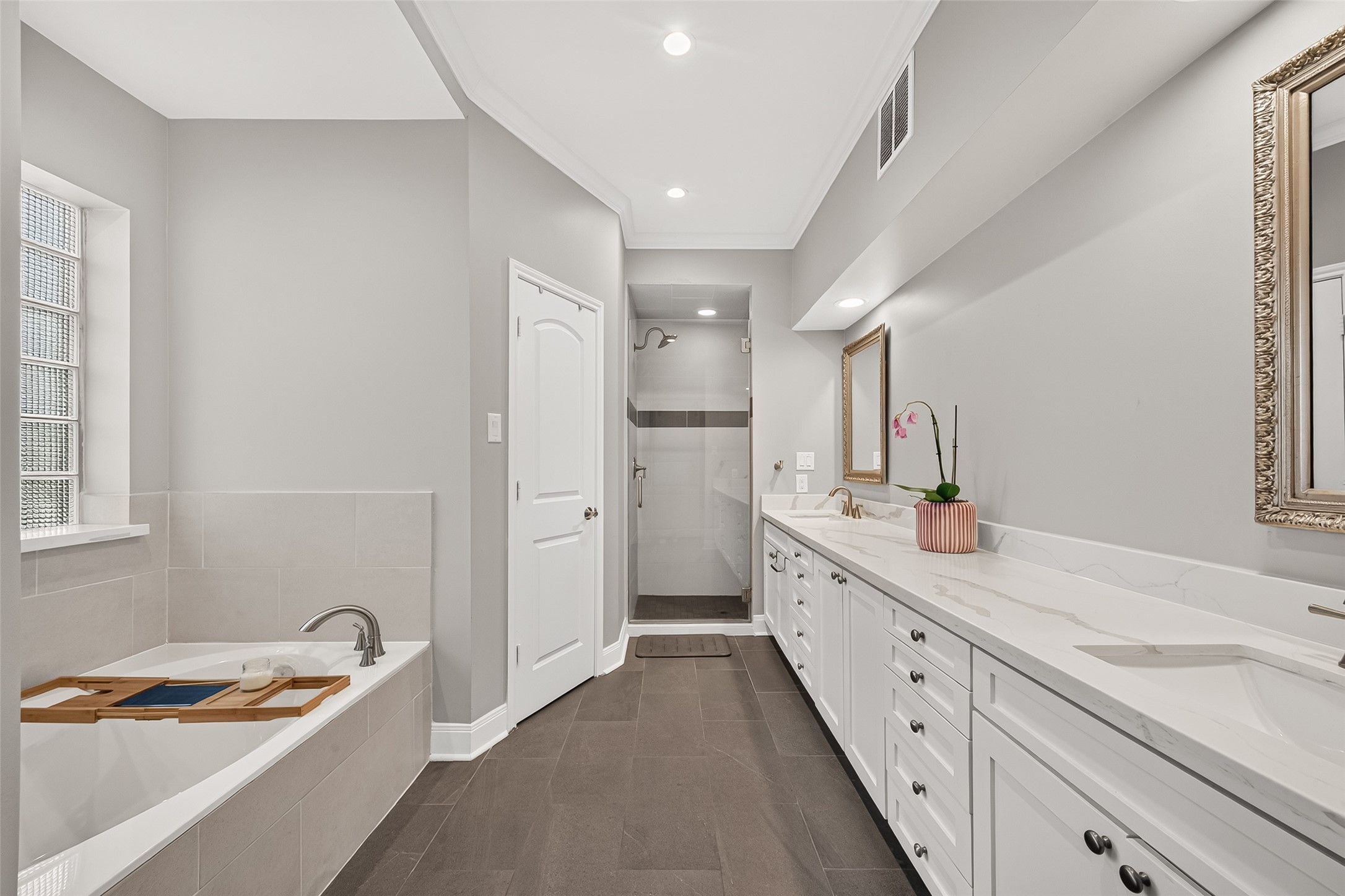Primary bathroom has a soaking tub, separate shower, double sinks, and two walk in closets.
