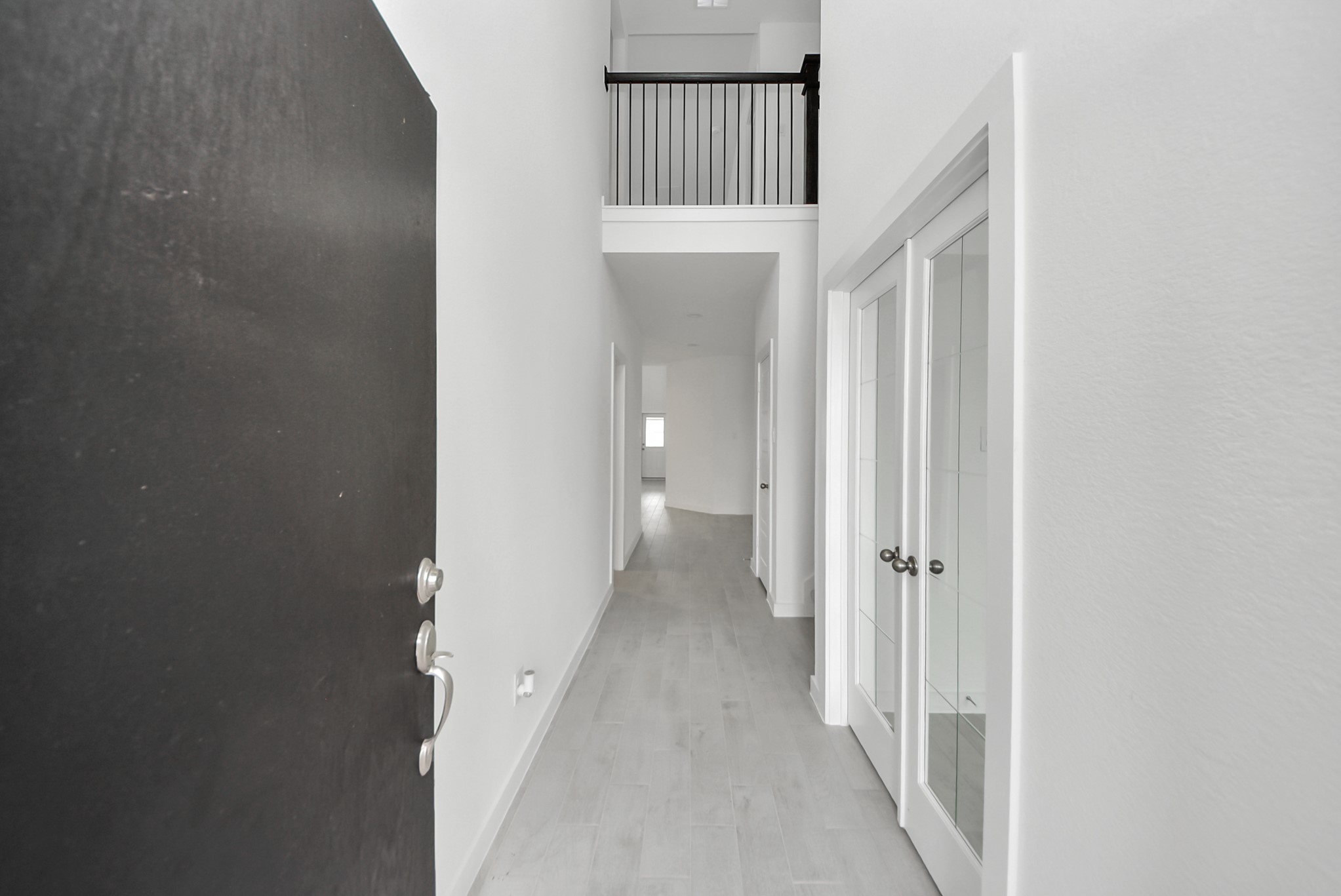 As you step into the threshold of this luxurious home, you'll soon be welcomed by an elegant glass door (to be installed). Inside, soaring ceilings amplify the spaciousness, while the refined wood-look tile flooring and oversized baseboards exude sophistication and charm.