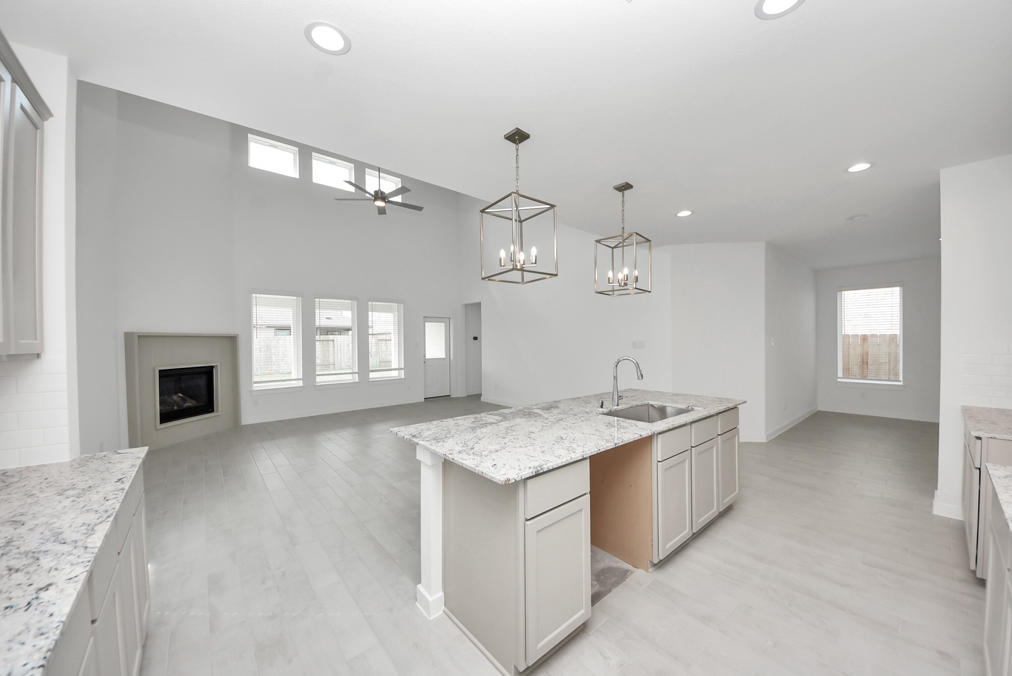 The open concept effortlessly connects the kitchen to the expansive family room, forming a perfect hub for gatherings. This seamless flow creates an inviting space where cooking and socializing come together harmoniously.