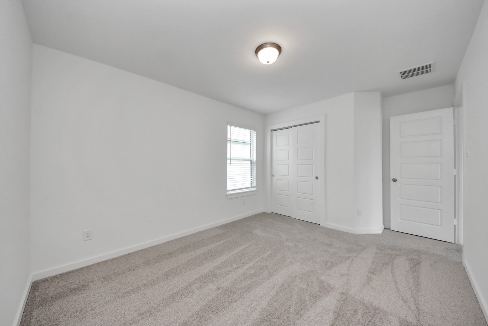 Generously sized secondary bedrooms featuring spacious closets, soft and inviting carpeting underfoot, large windows allowing plenty of natural light, and the added touch of privacy blinds for your personal retreat.