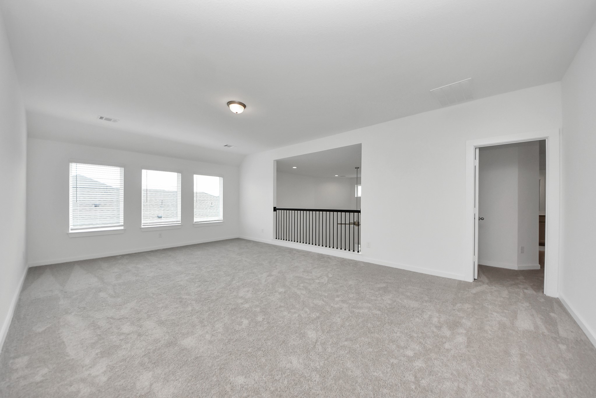 Come upstairs and enjoy a day of leisure in this fabulous game room! This is the perfect hangout spot or adult game room! Features plush carpet, high ceilings, custom paint and windows for plenty of natural light.
